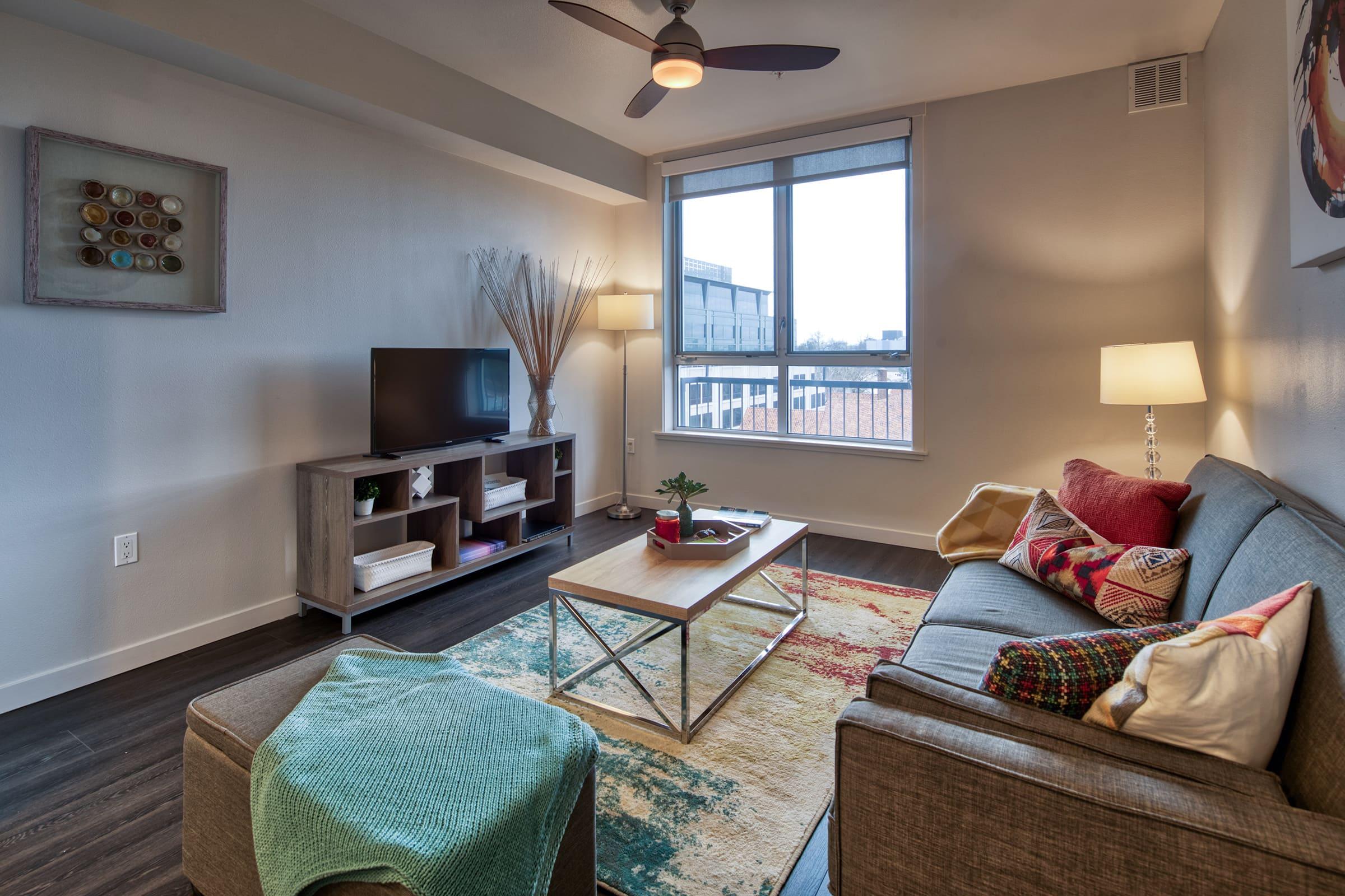 window and ceiling fan in the living room.