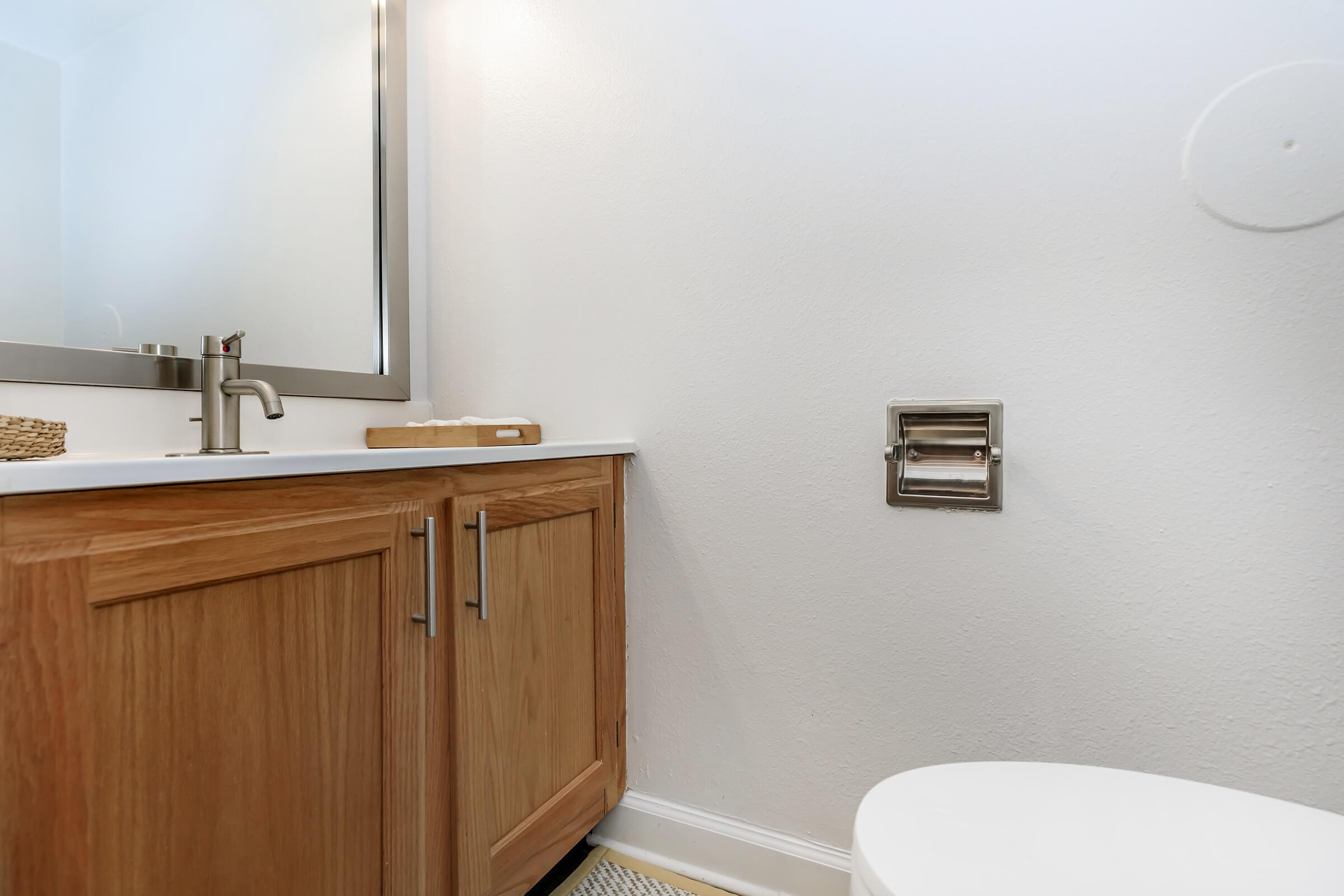 a kitchen with a sink and a mirror