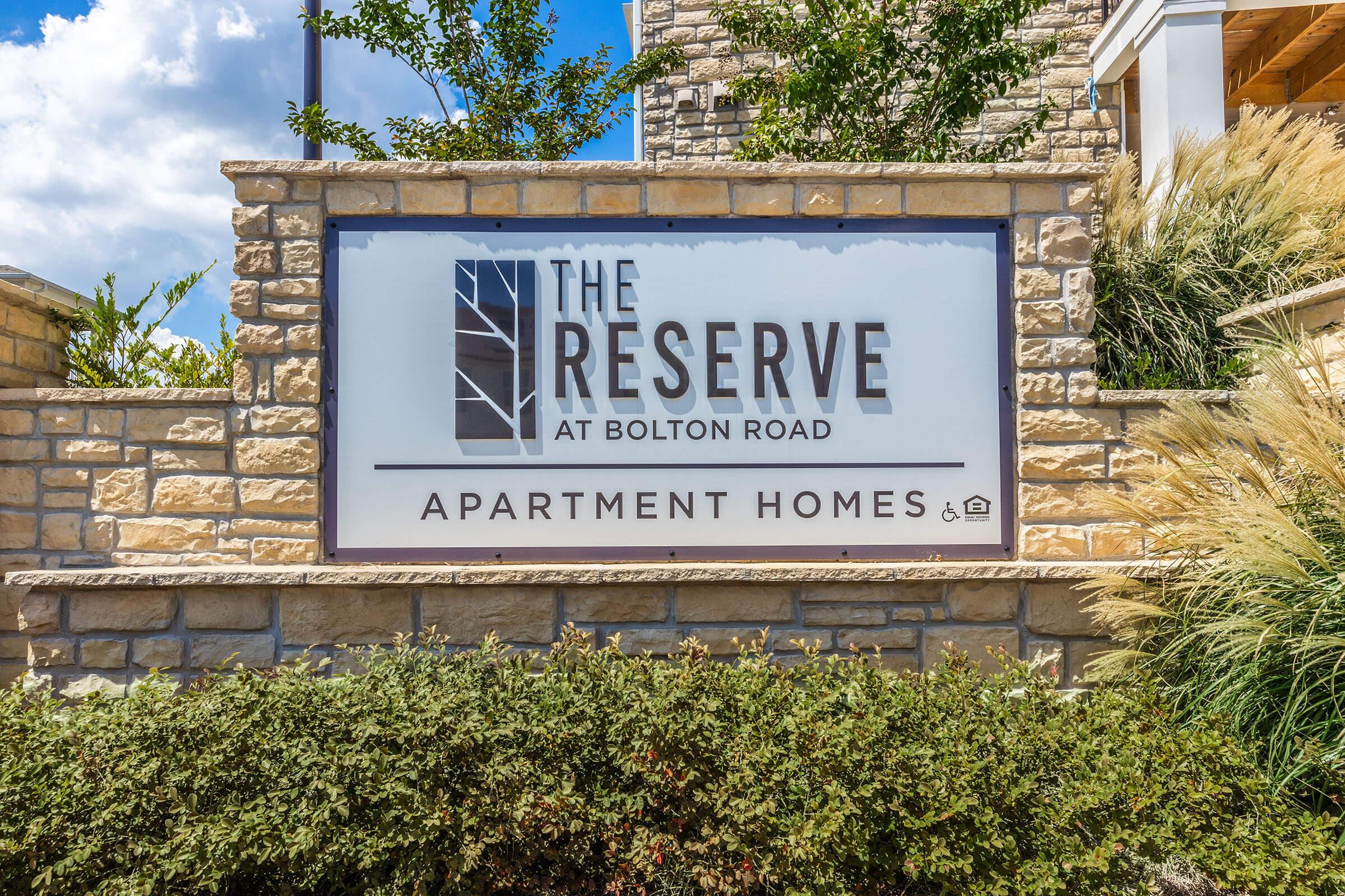 a sign in front of a brick building