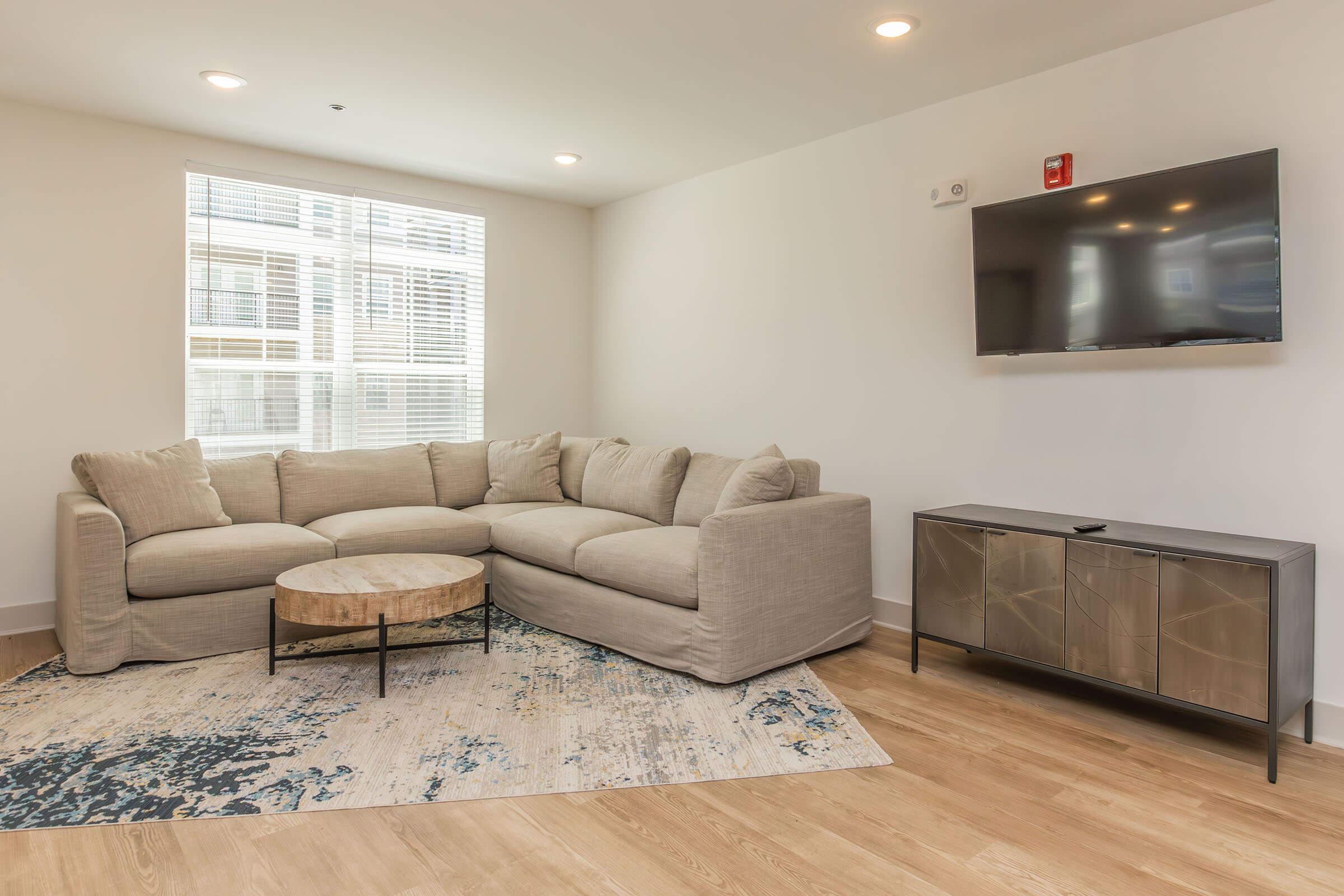 a living room filled with furniture and a large window