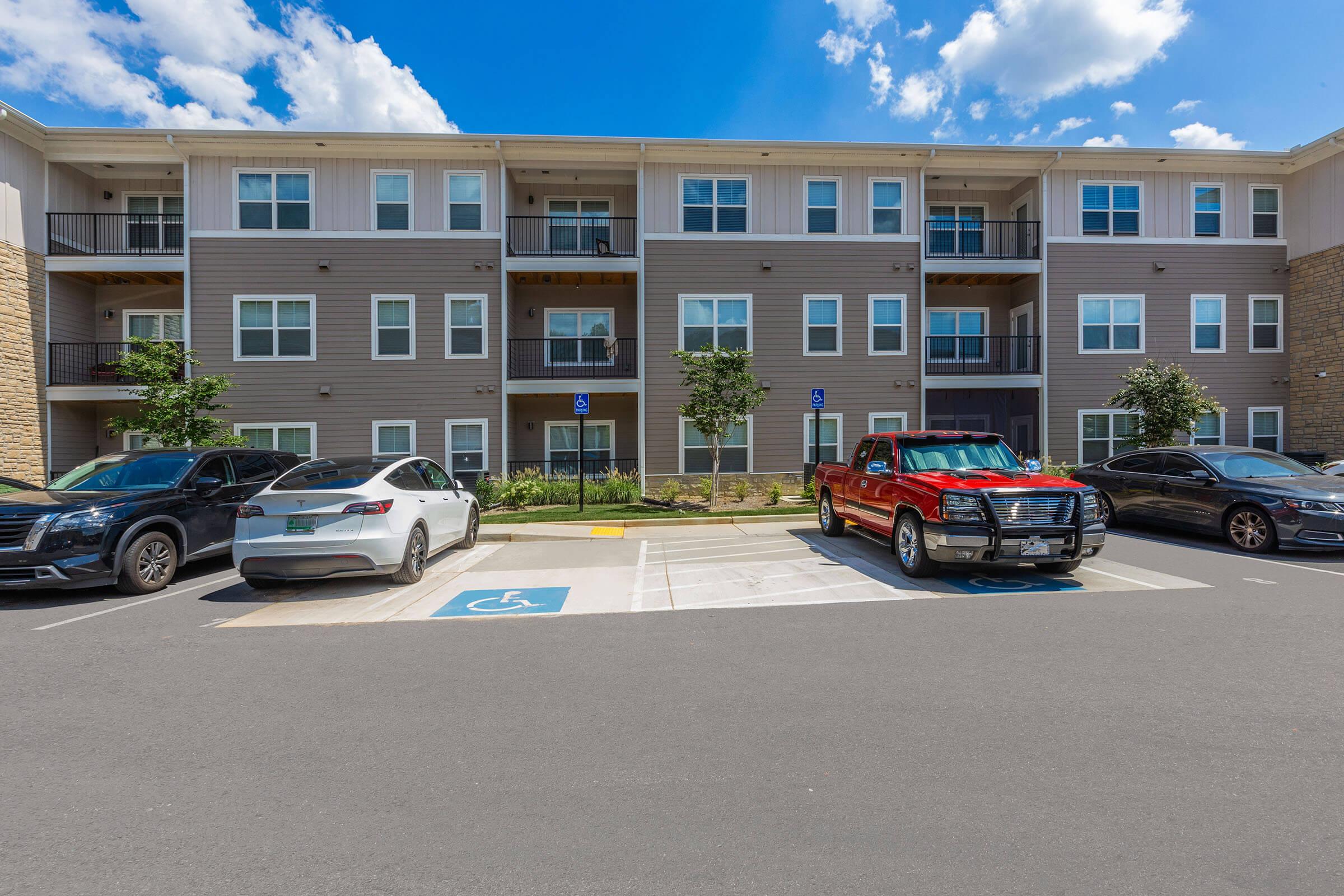 a car parked in a parking lot in front of a building