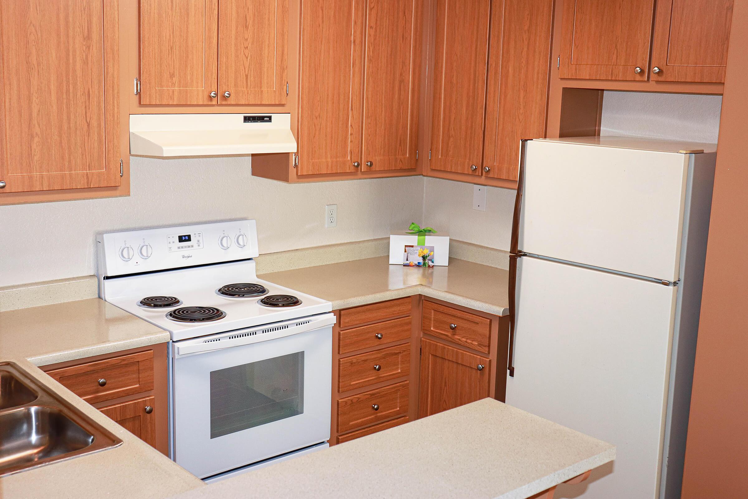 a kitchen with a stove top oven sitting inside of a wooden counter