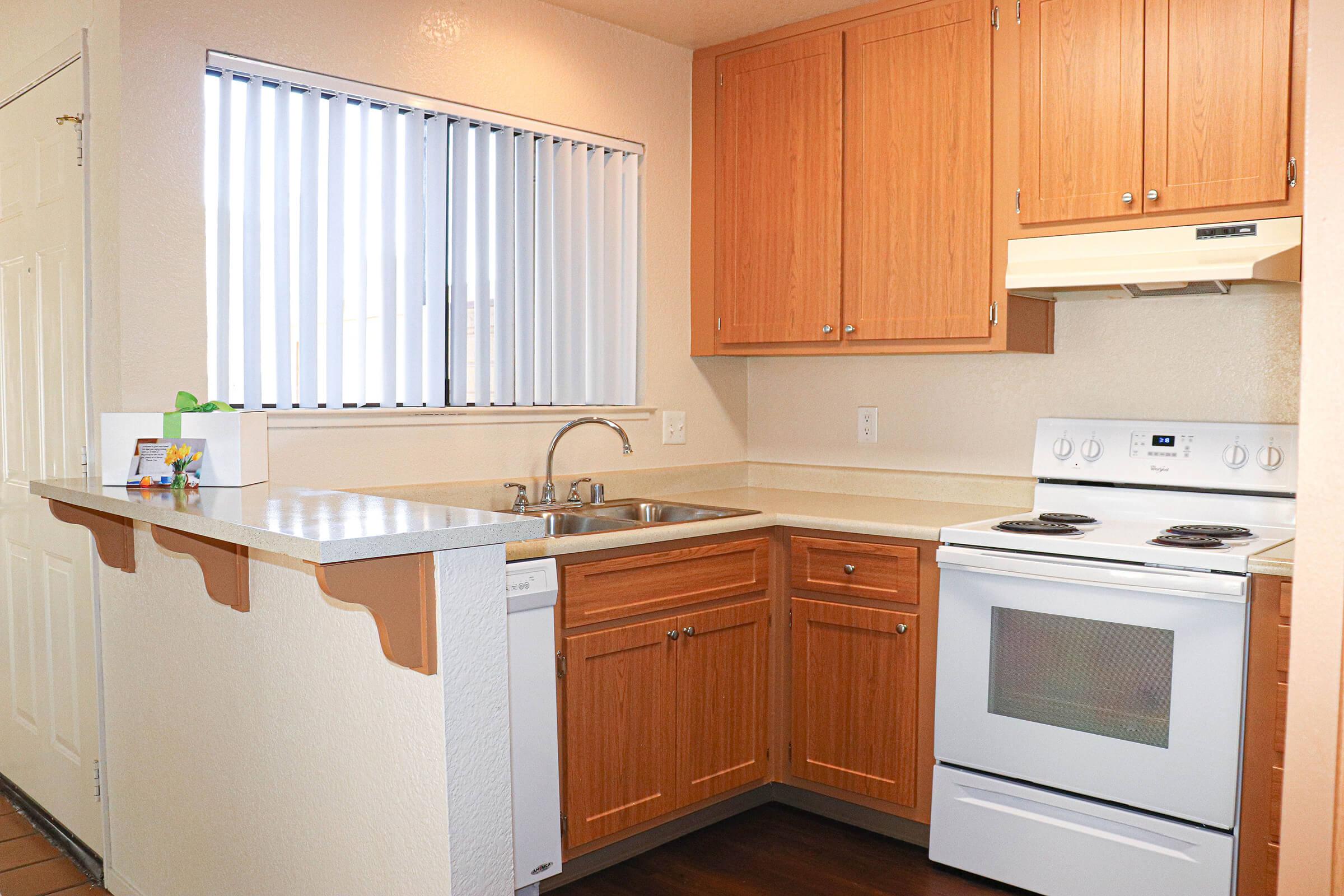 a white stove top oven sitting inside of a kitchen