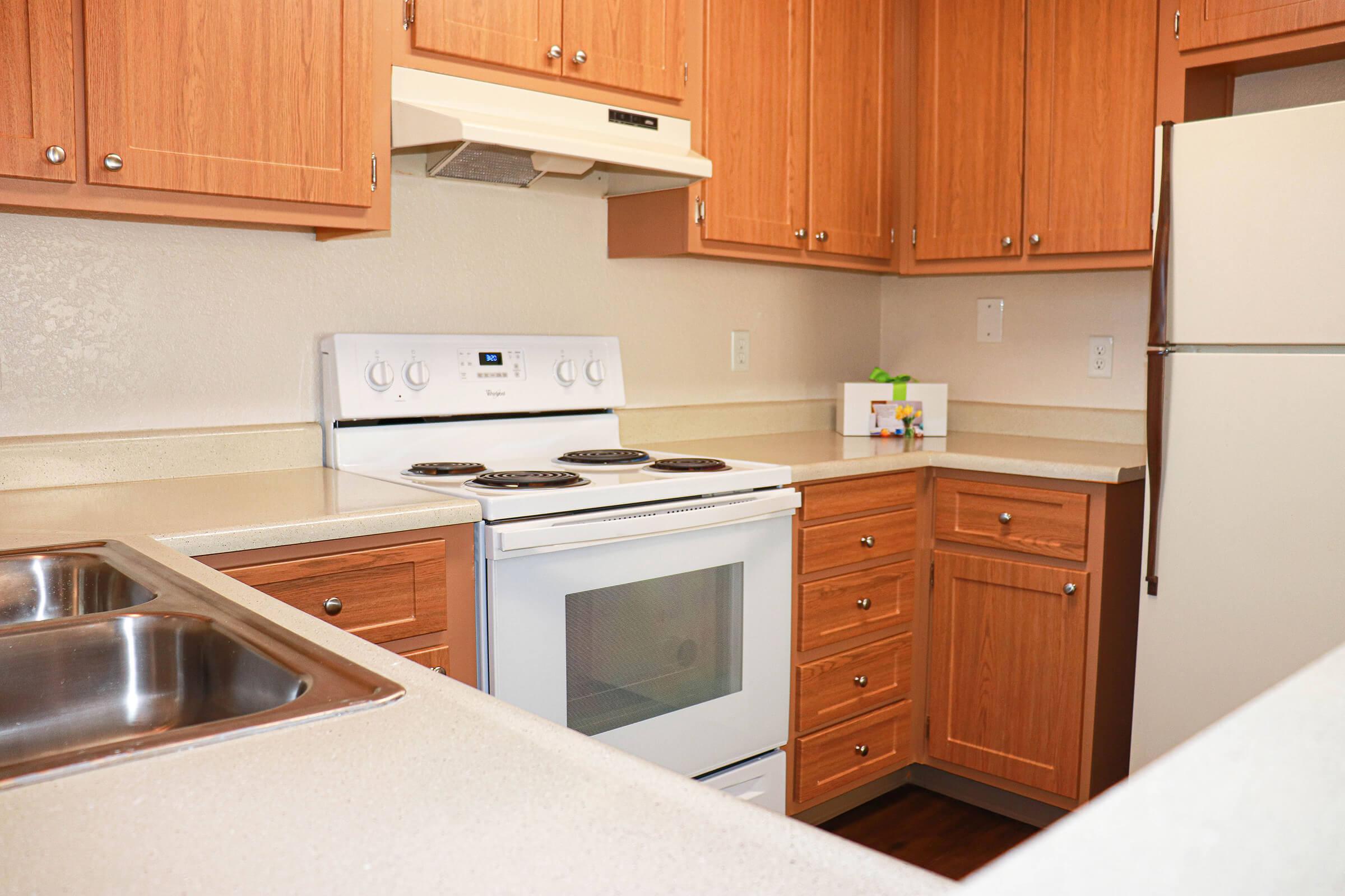 a kitchen with stainless steel appliances and wooden cabinets