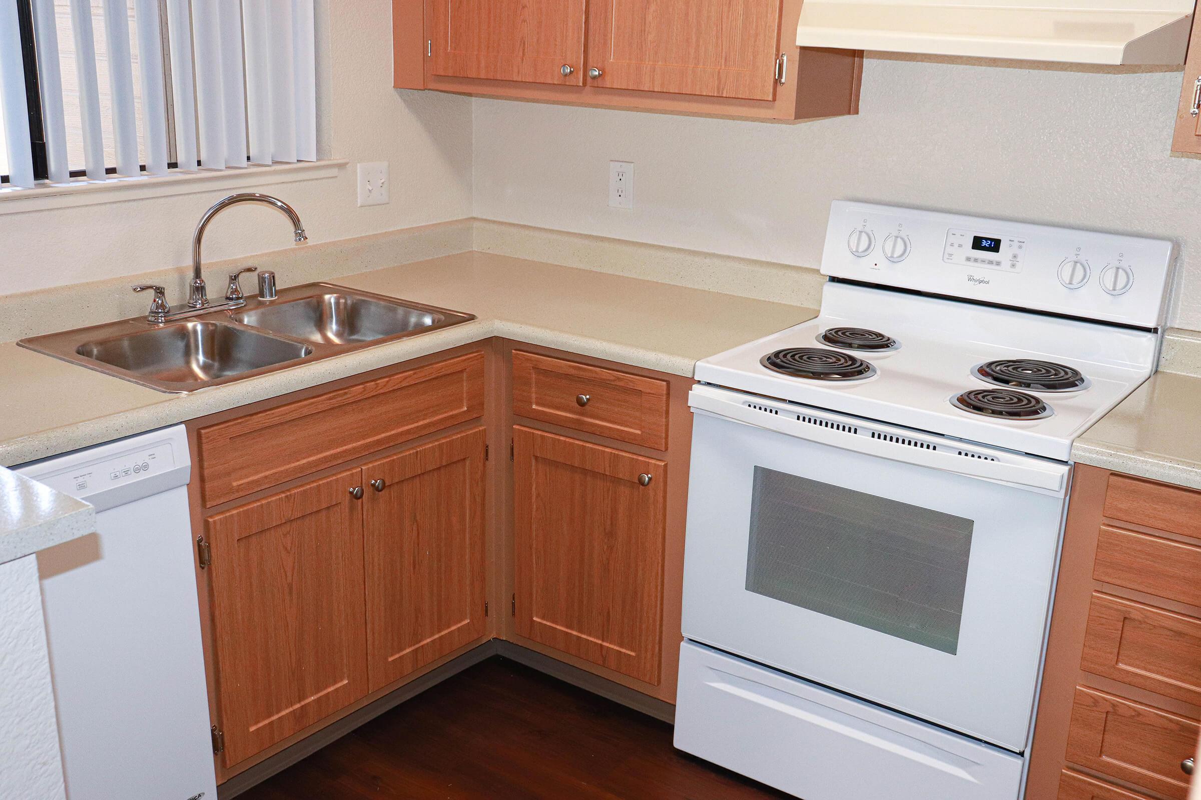 a kitchen with a stove a sink and a microwave