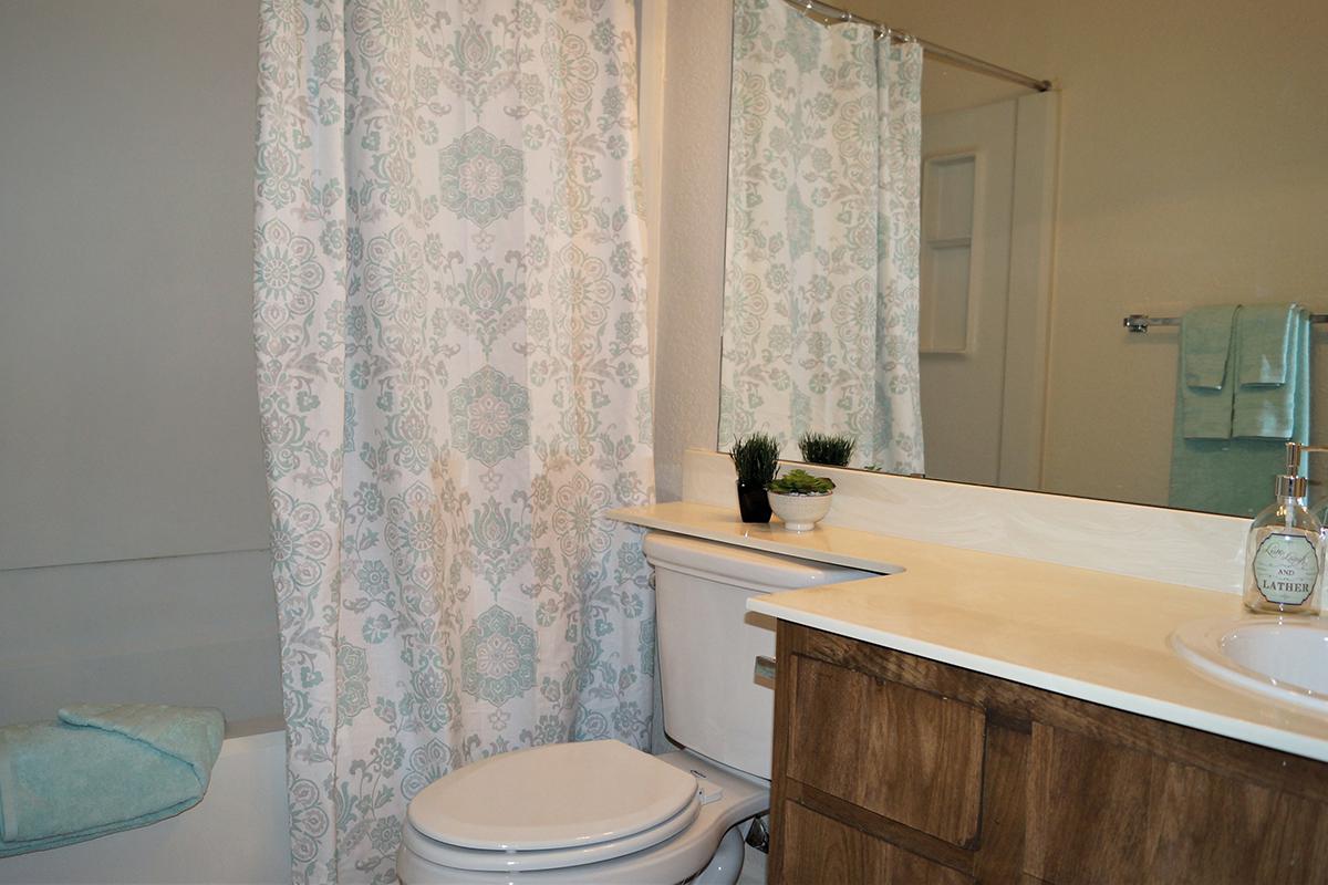 a white sink sitting next to a shower