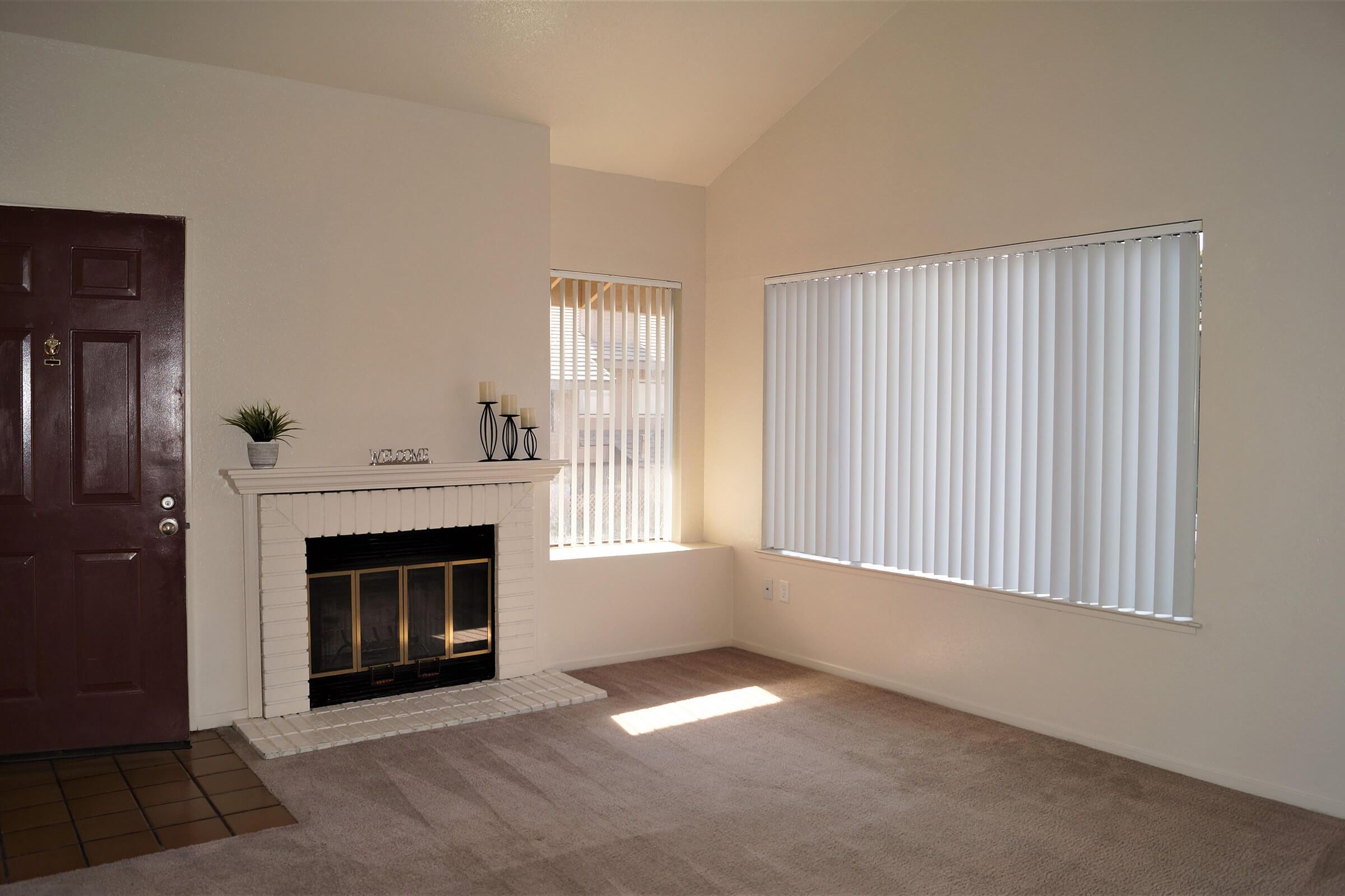 a living room filled with furniture and a fireplace