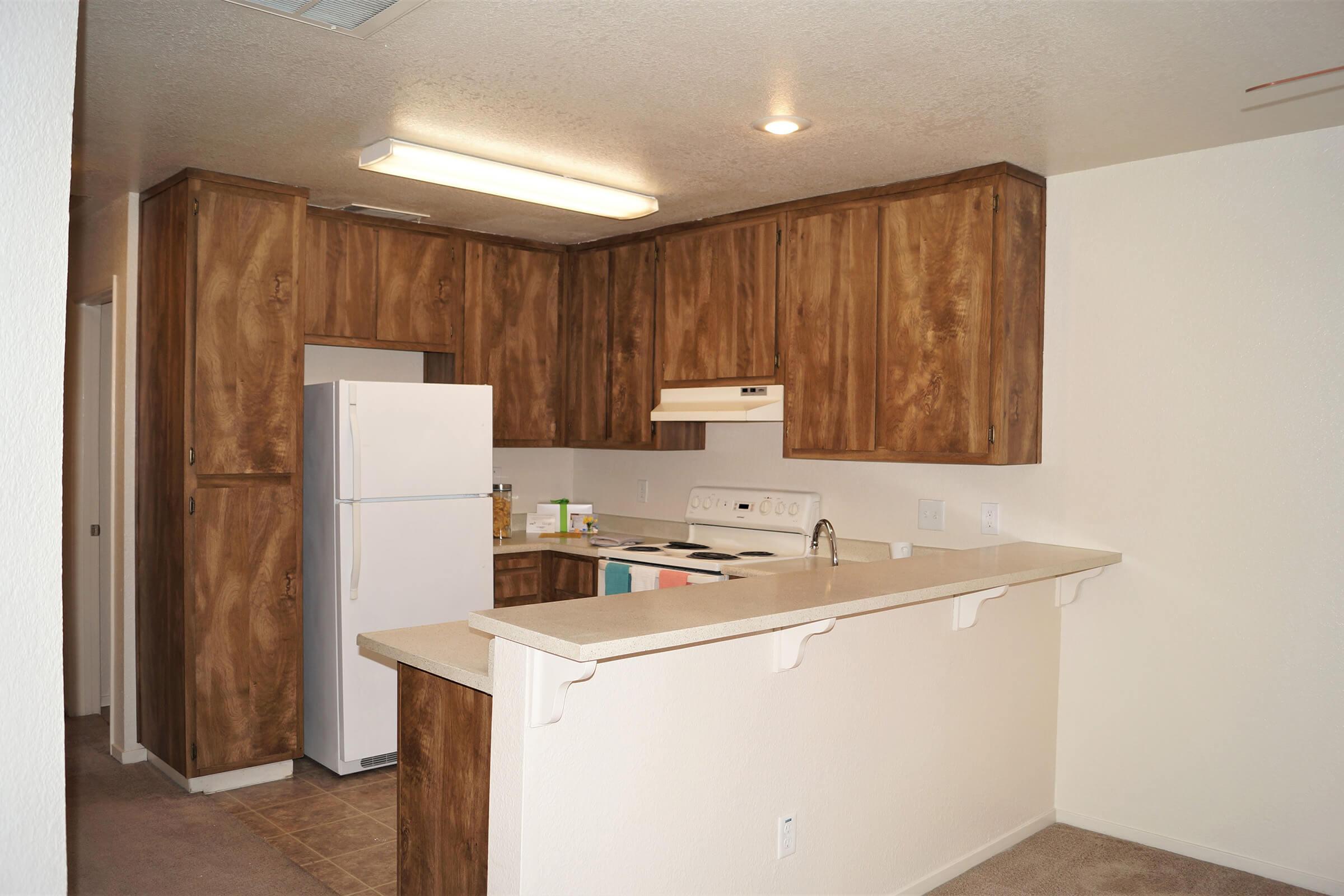 a white refrigerator freezer sitting inside of a kitchen