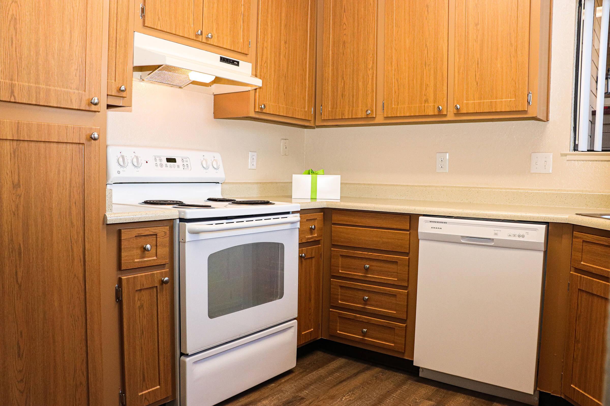 a kitchen with wooden cabinets and a microwave