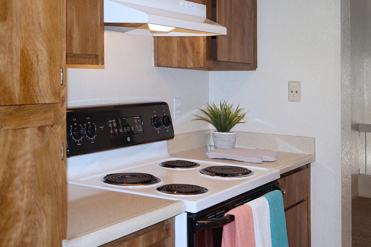 a white stove top oven sitting inside of a kitchen