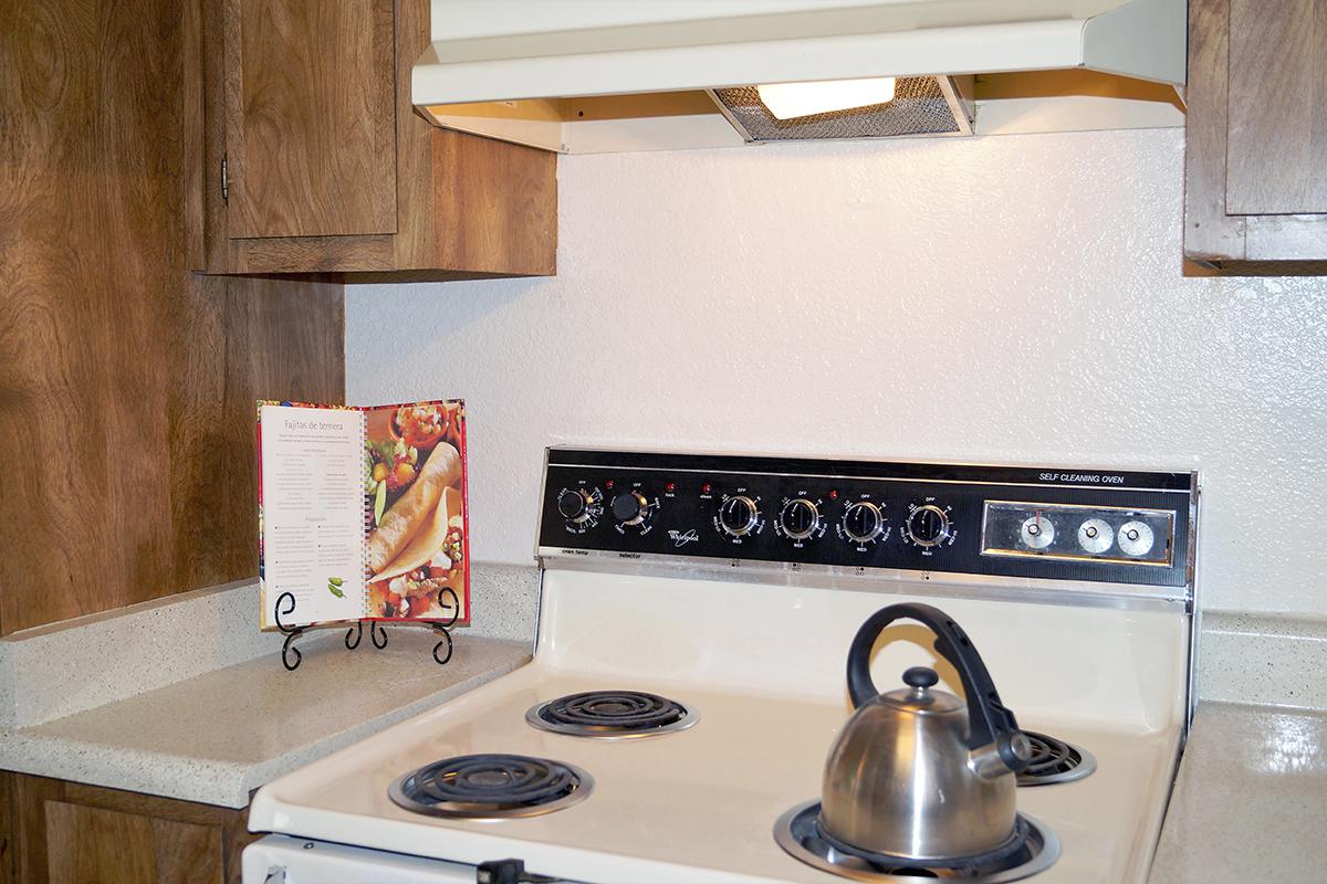 a stove top oven sitting inside of a kitchen