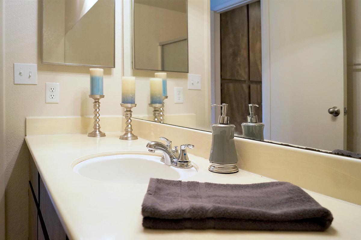 a hotel room with a sink and a mirror