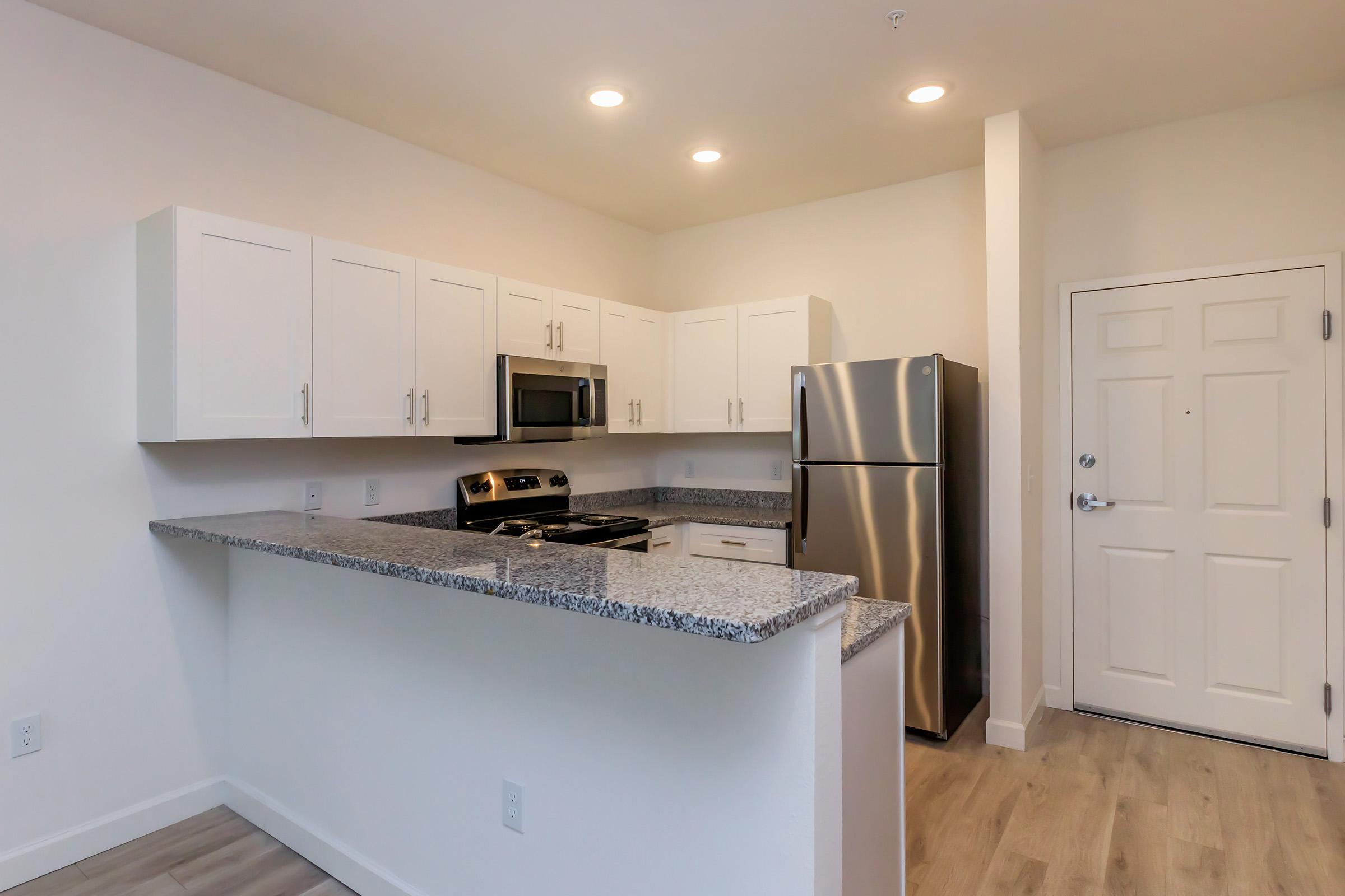 a kitchen with a sink and a refrigerator