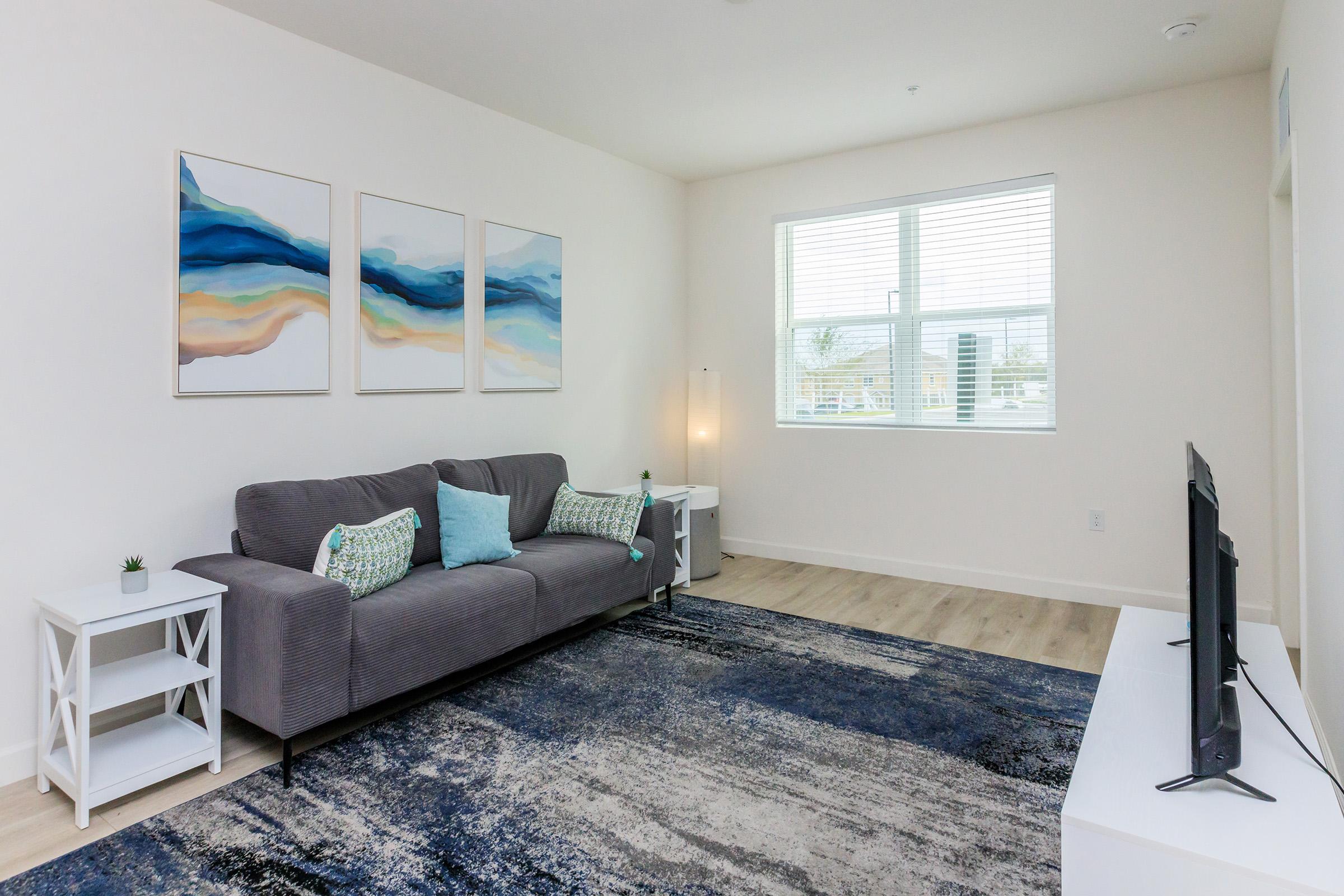 a living room with a bed and a window