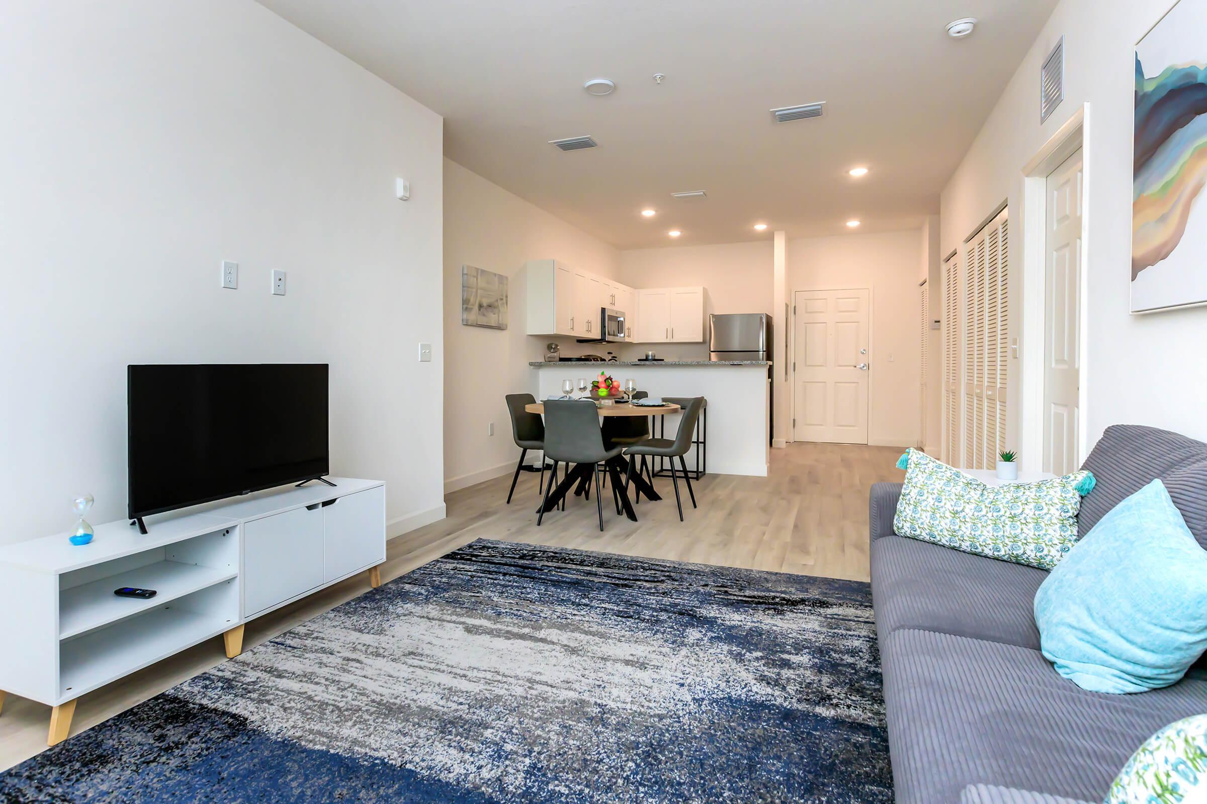 a living room filled with furniture and a flat screen tv