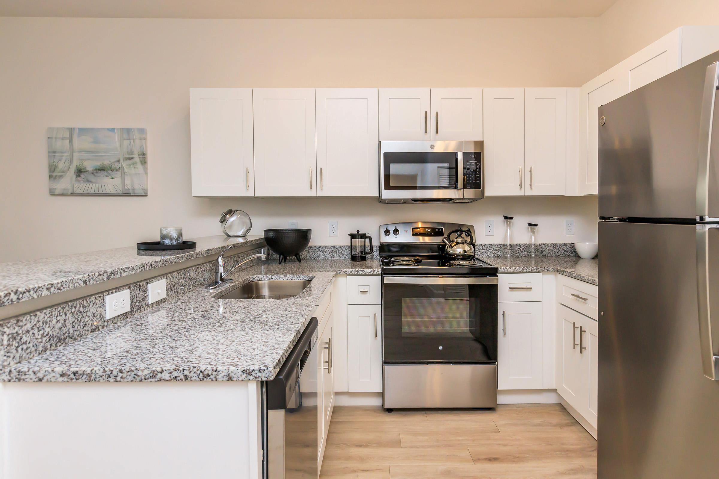 a kitchen with stainless steel appliances and wooden cabinets