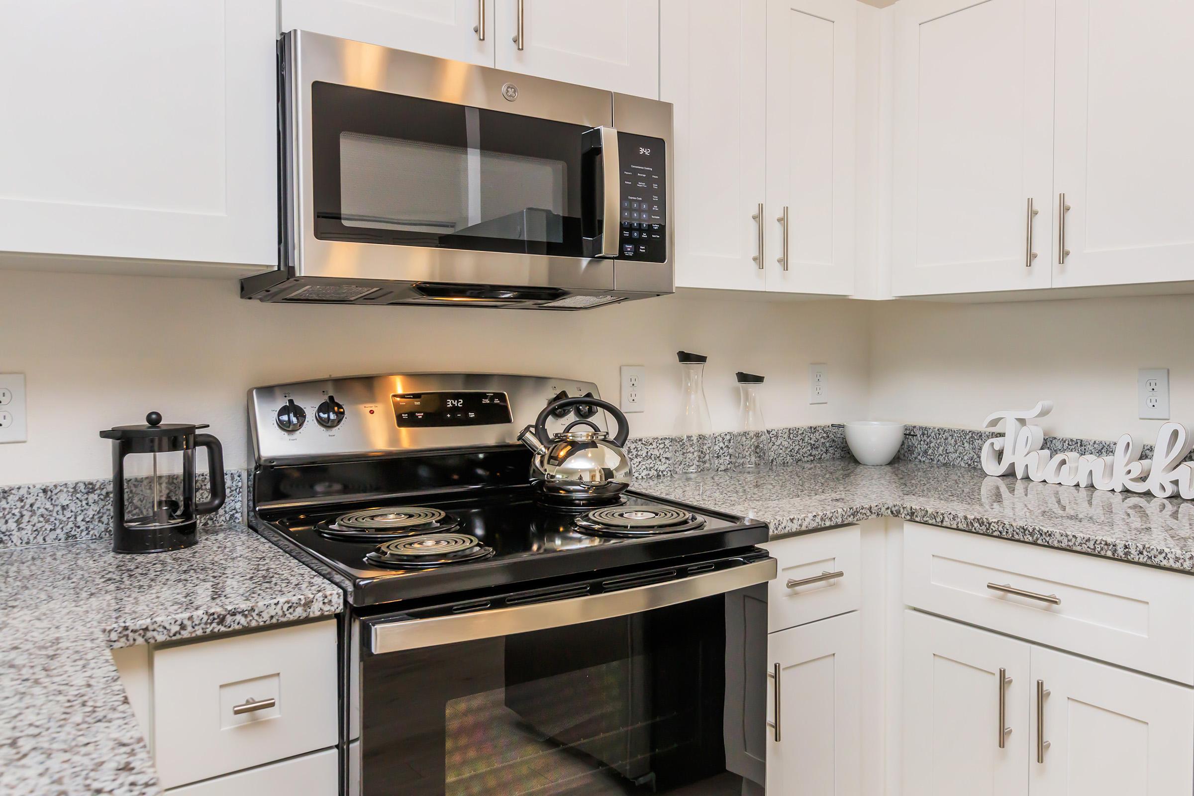 a stove top oven sitting inside of a kitchen