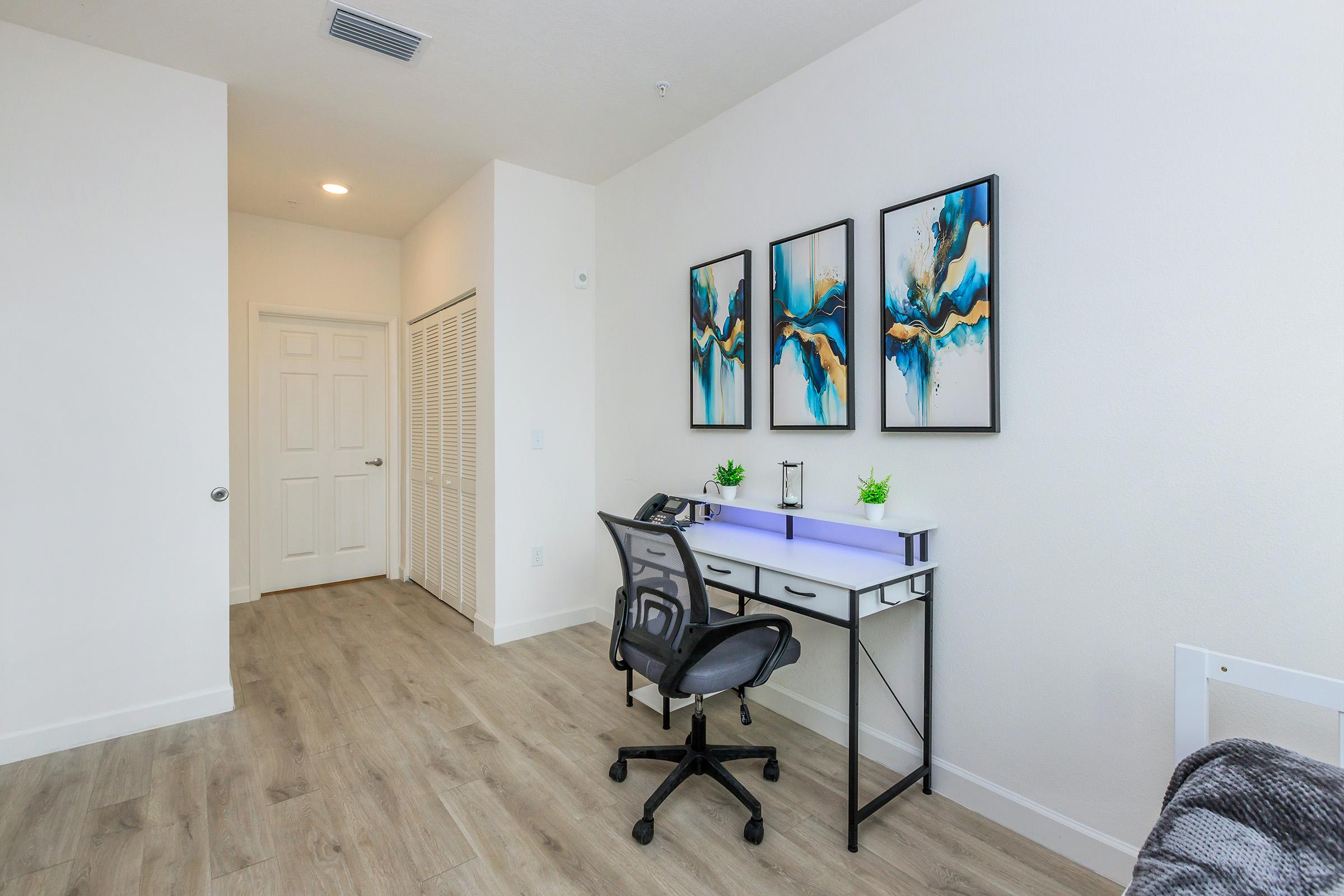 a bedroom with a wooden floor