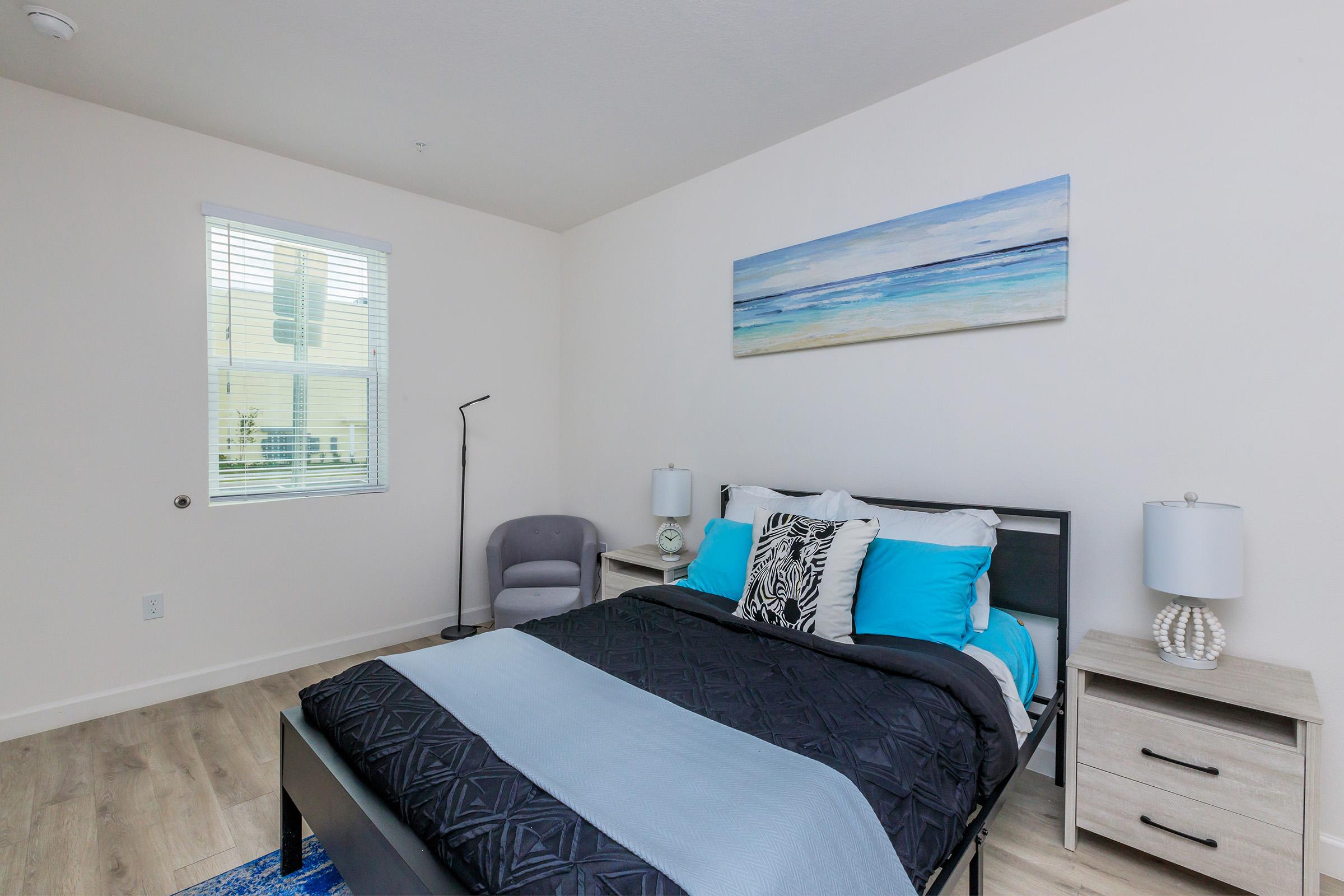 a bedroom with a bed and desk in a room