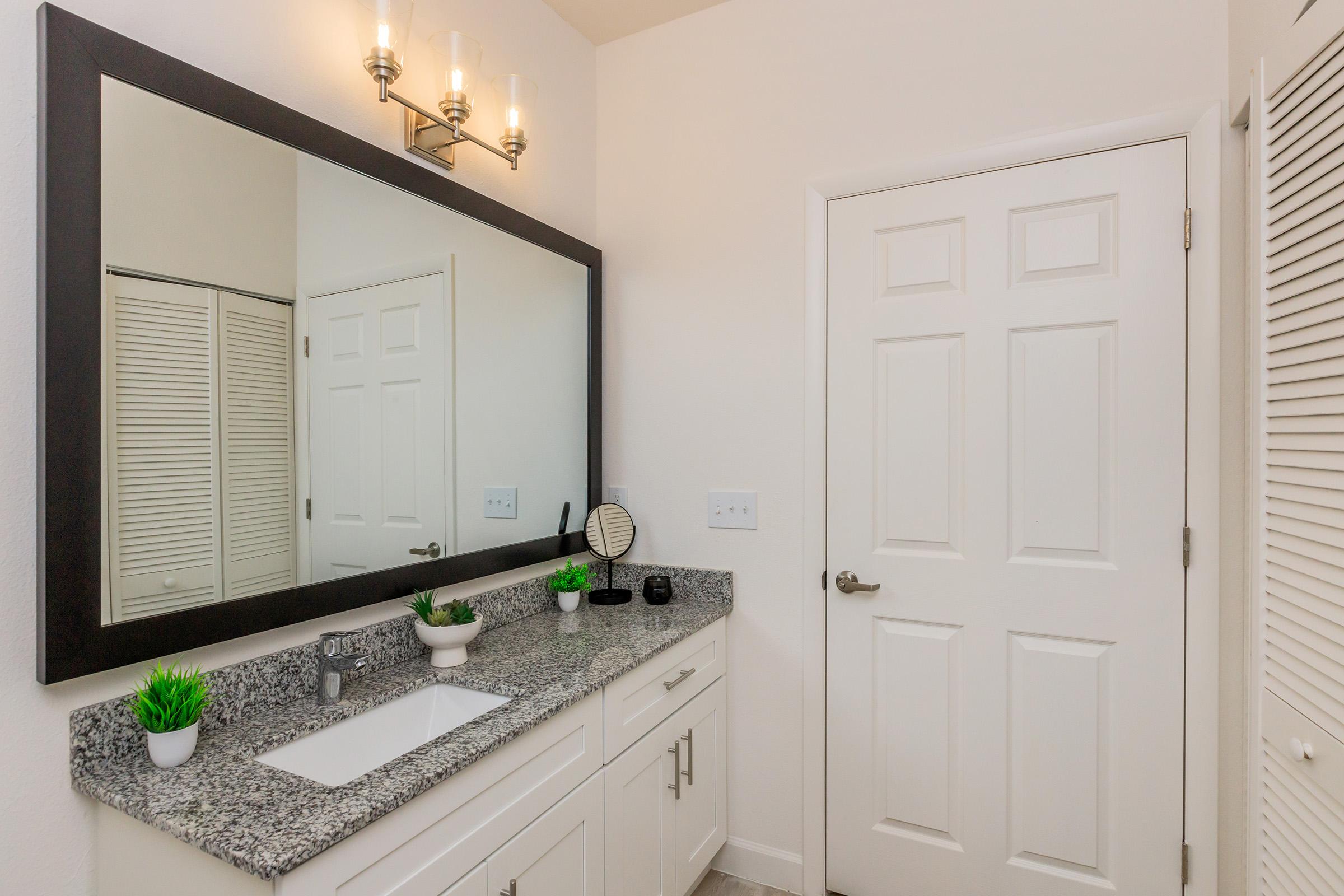 a kitchen with a sink and a mirror