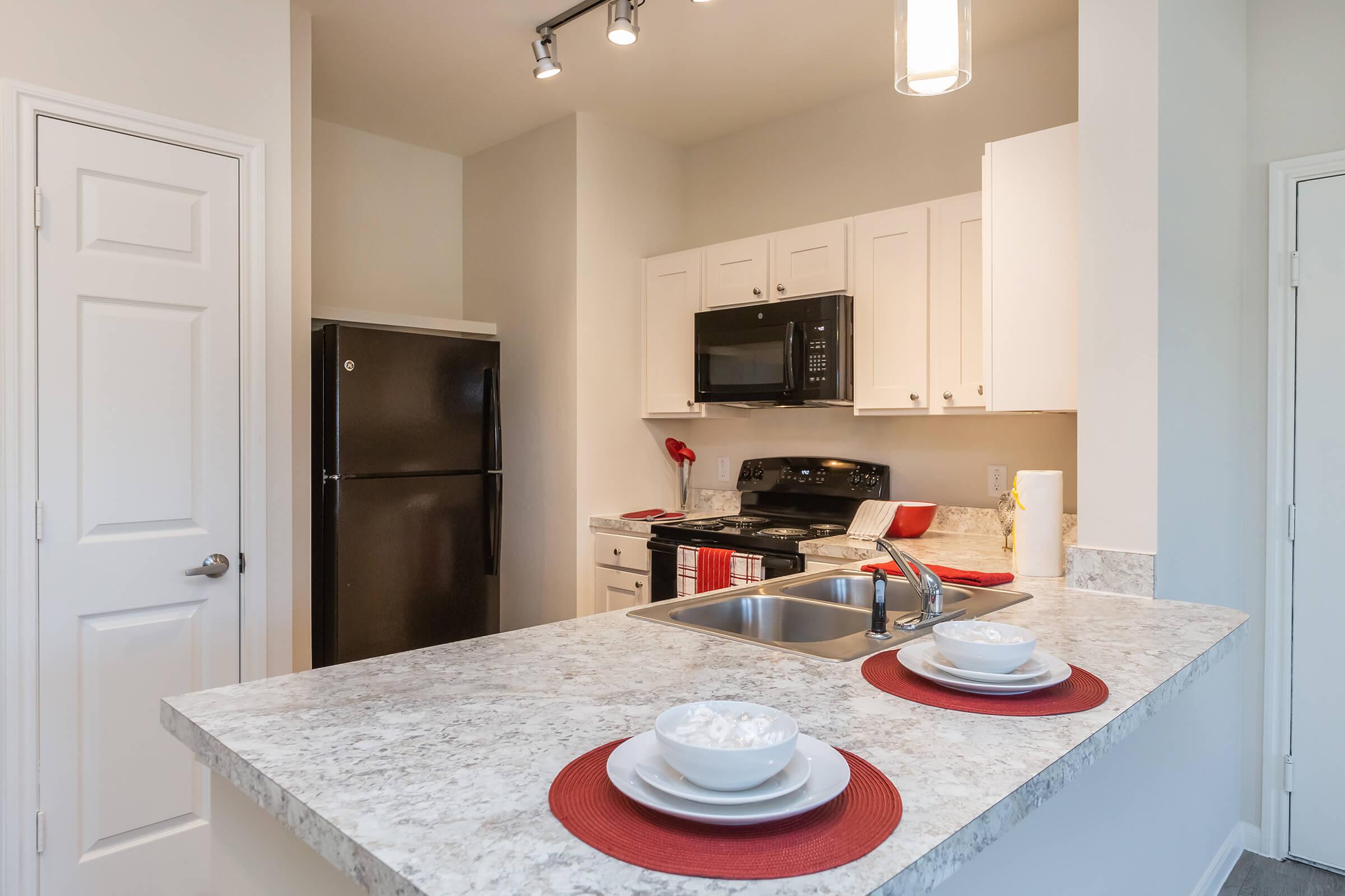 a kitchen with a sink and a refrigerator