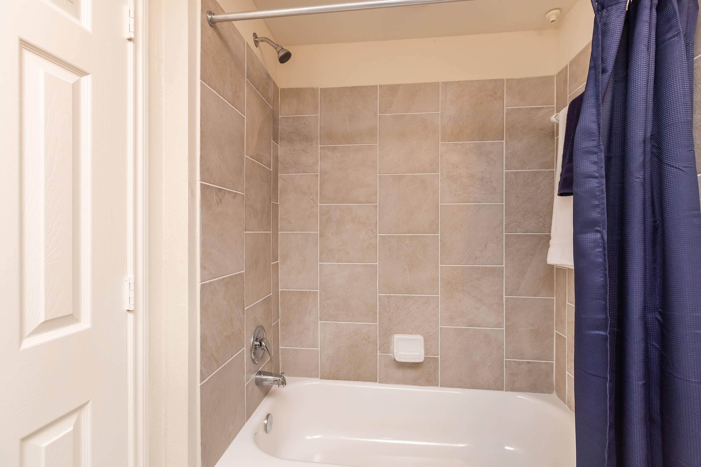 a white tub sitting next to a sink