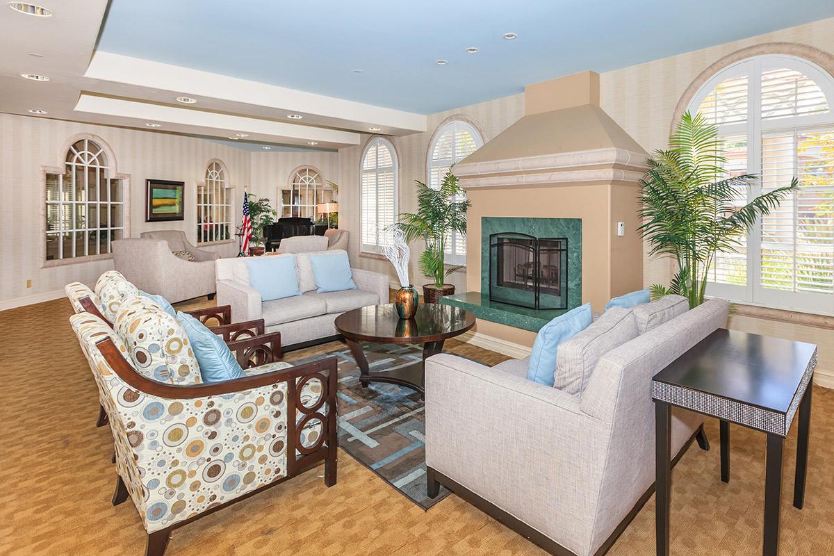 a living room filled with furniture and a large window