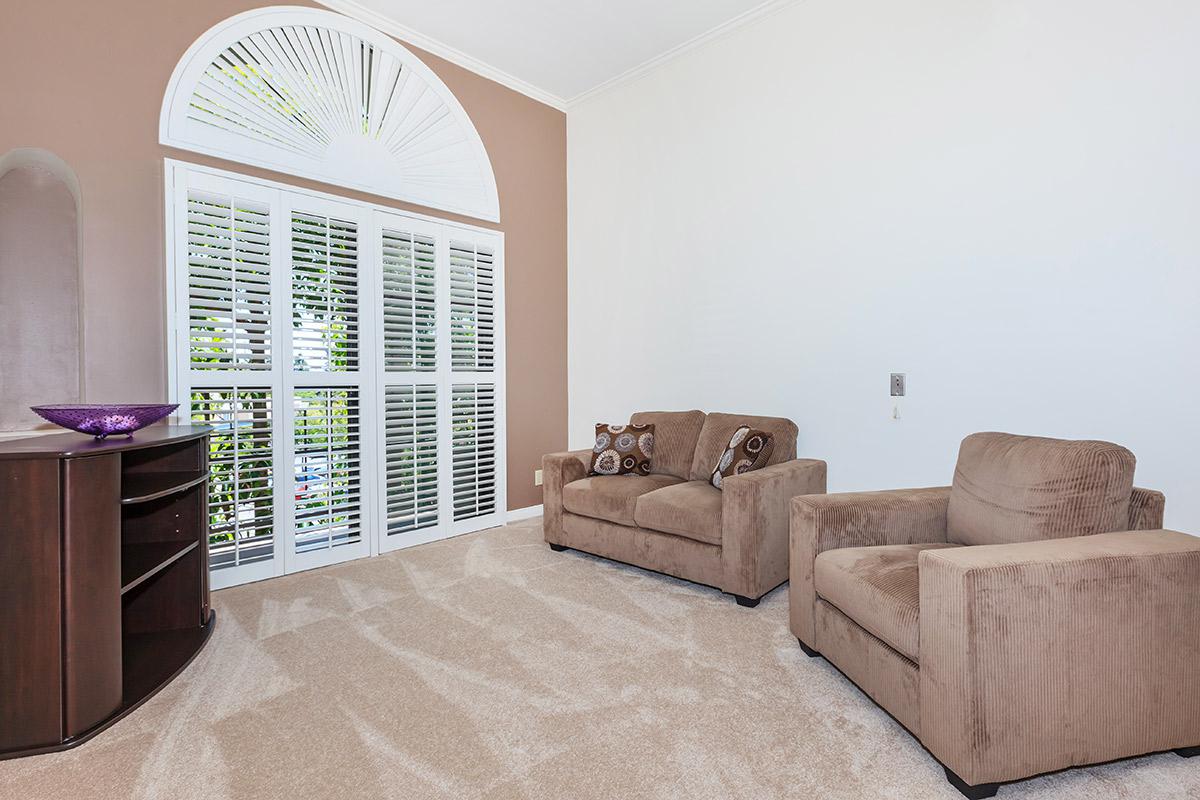 a living room filled with furniture and a large window