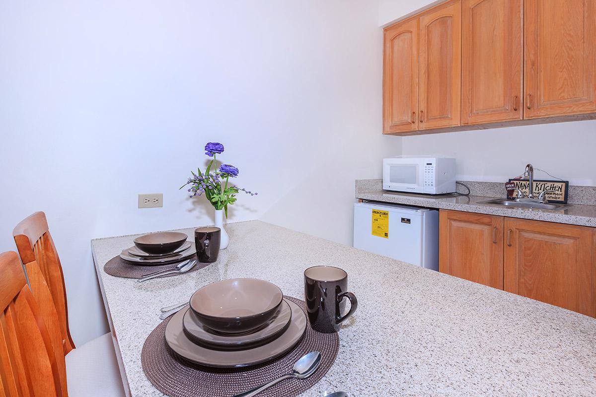 a kitchen with white appliances and wooden cabinets