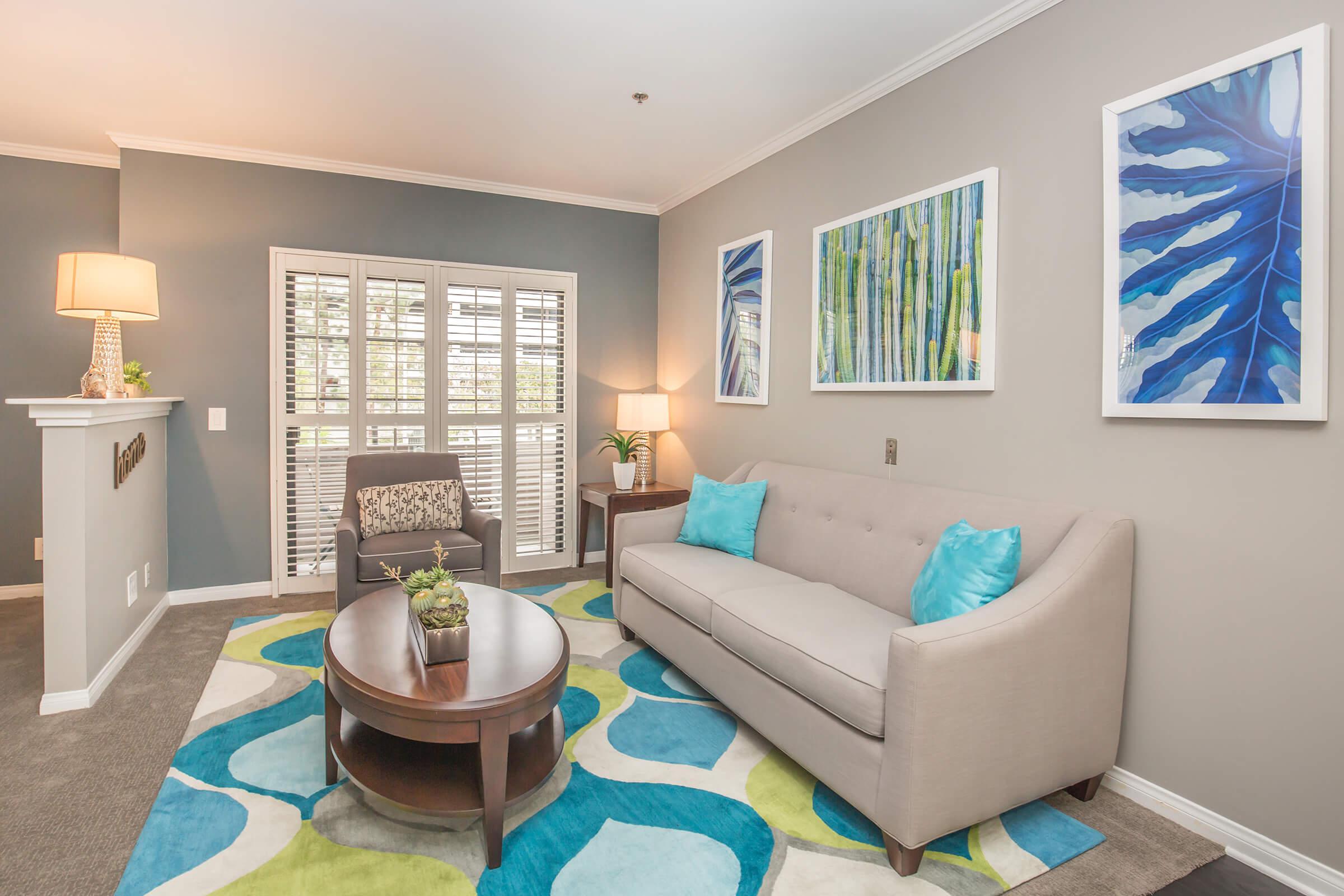 a living room filled with furniture and a large window