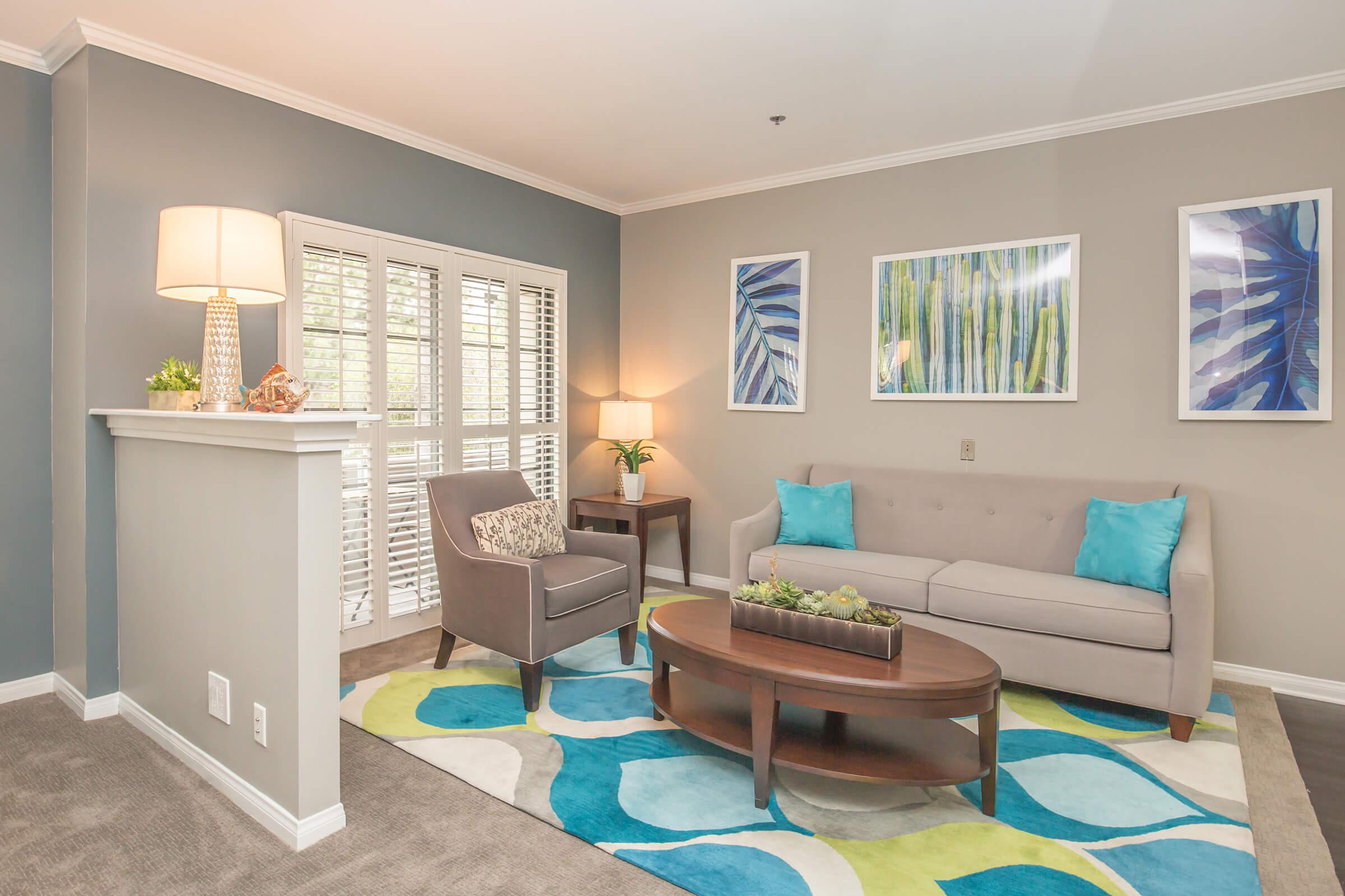 a living room filled with furniture and a large window