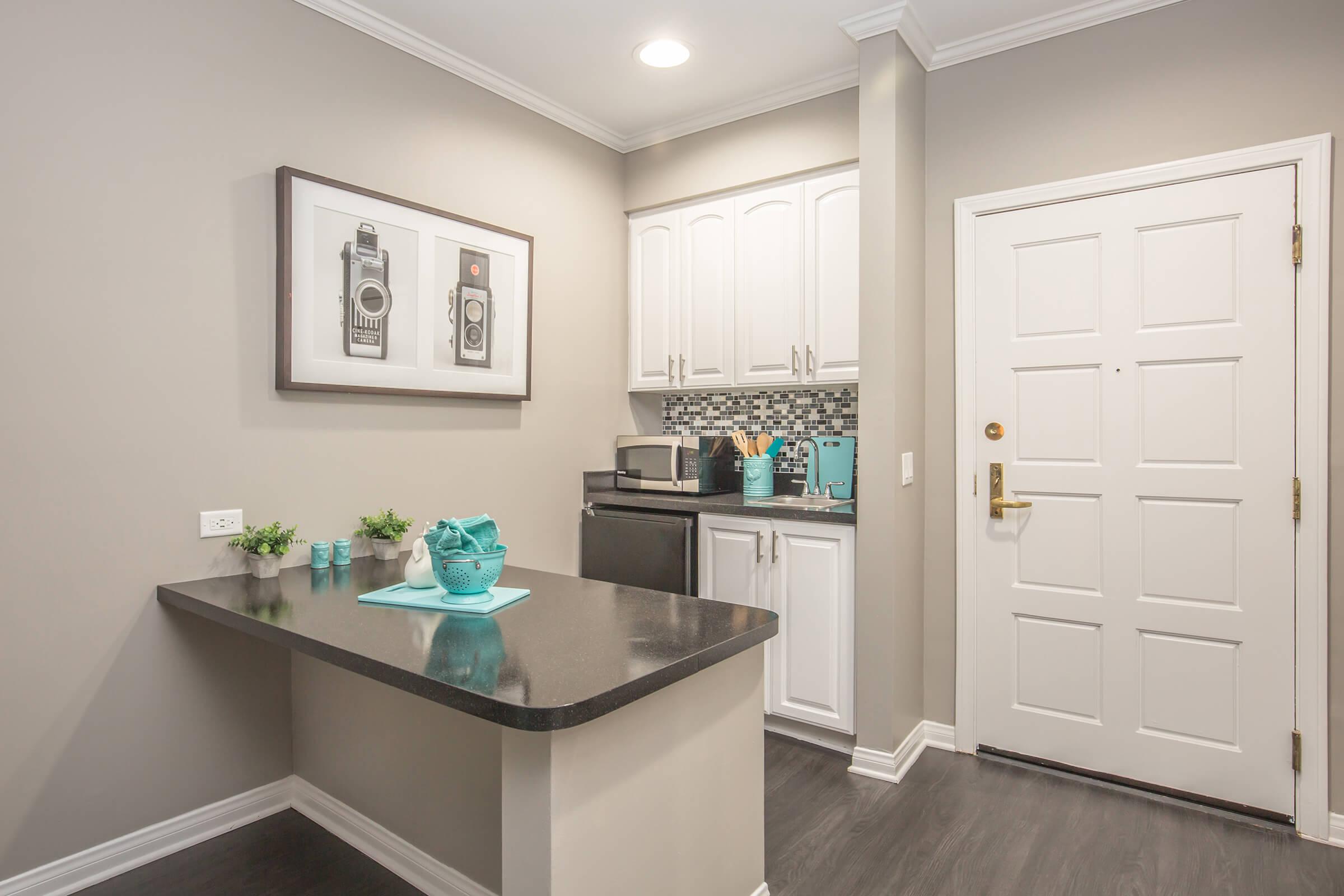 a kitchen with a sink and a mirror