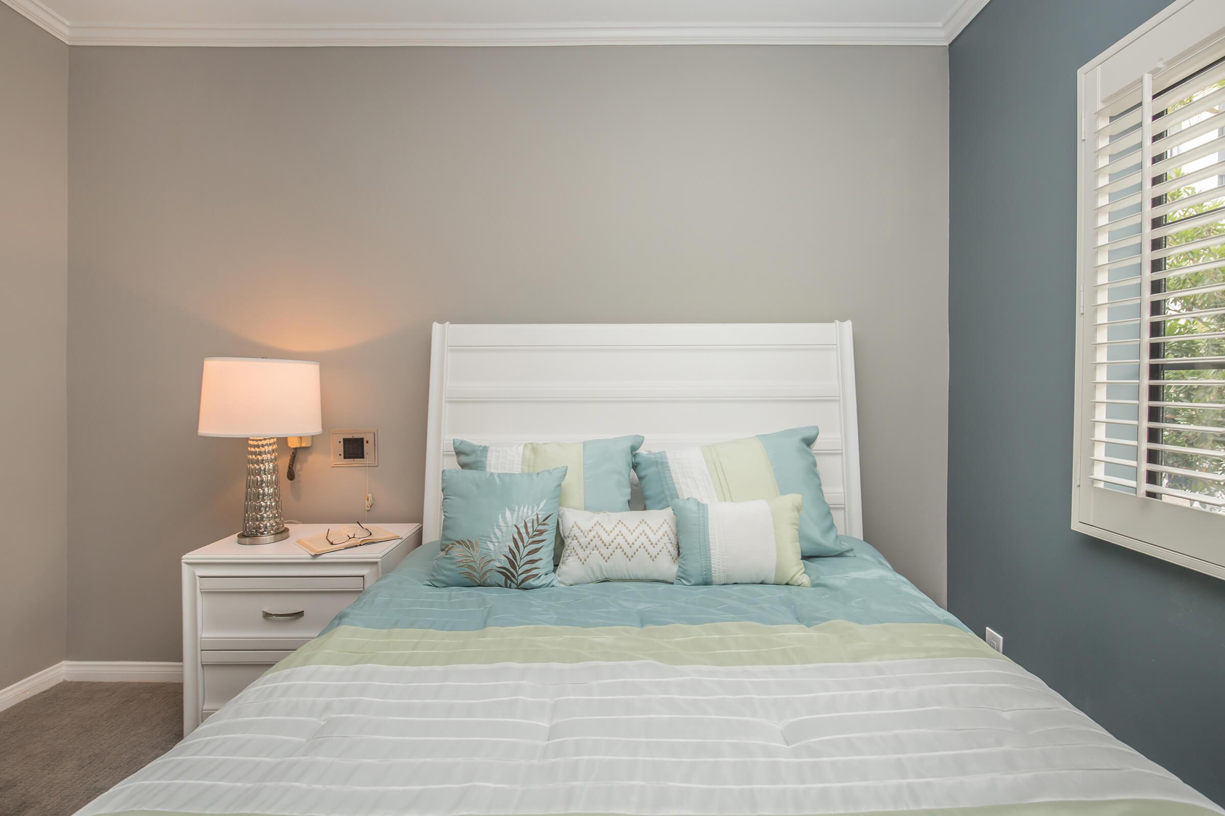 a bedroom with a bed in a room