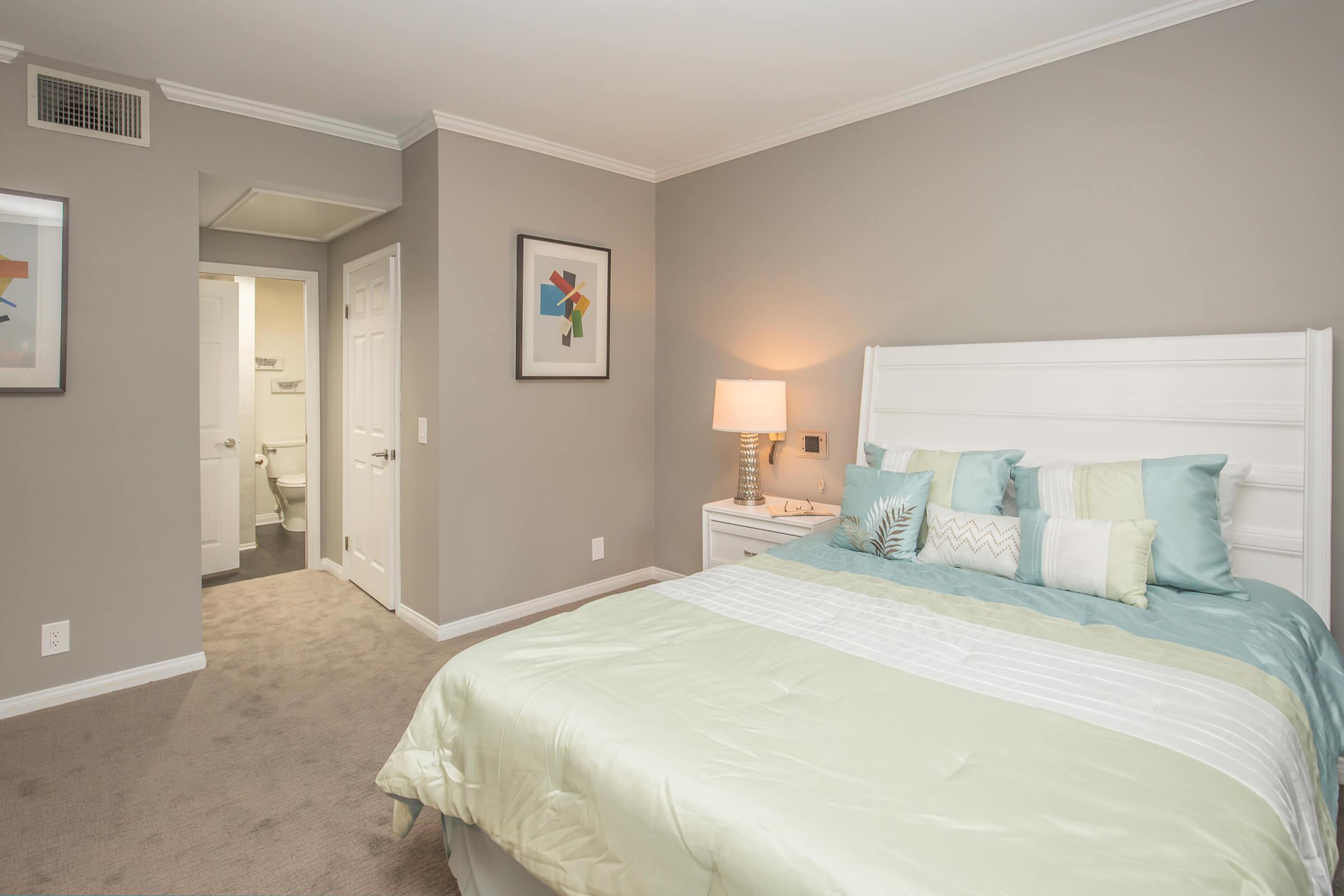a bedroom with a large bed in a room