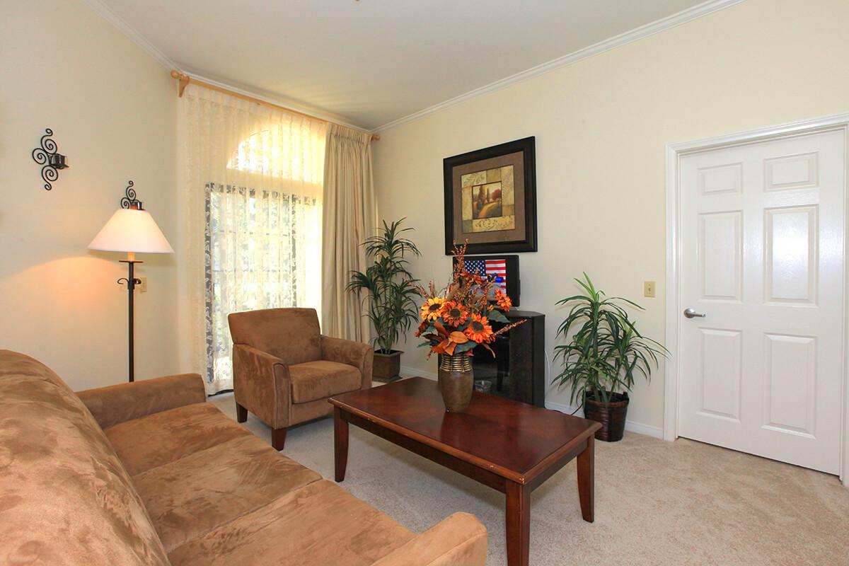 a living room filled with furniture and a flat screen tv