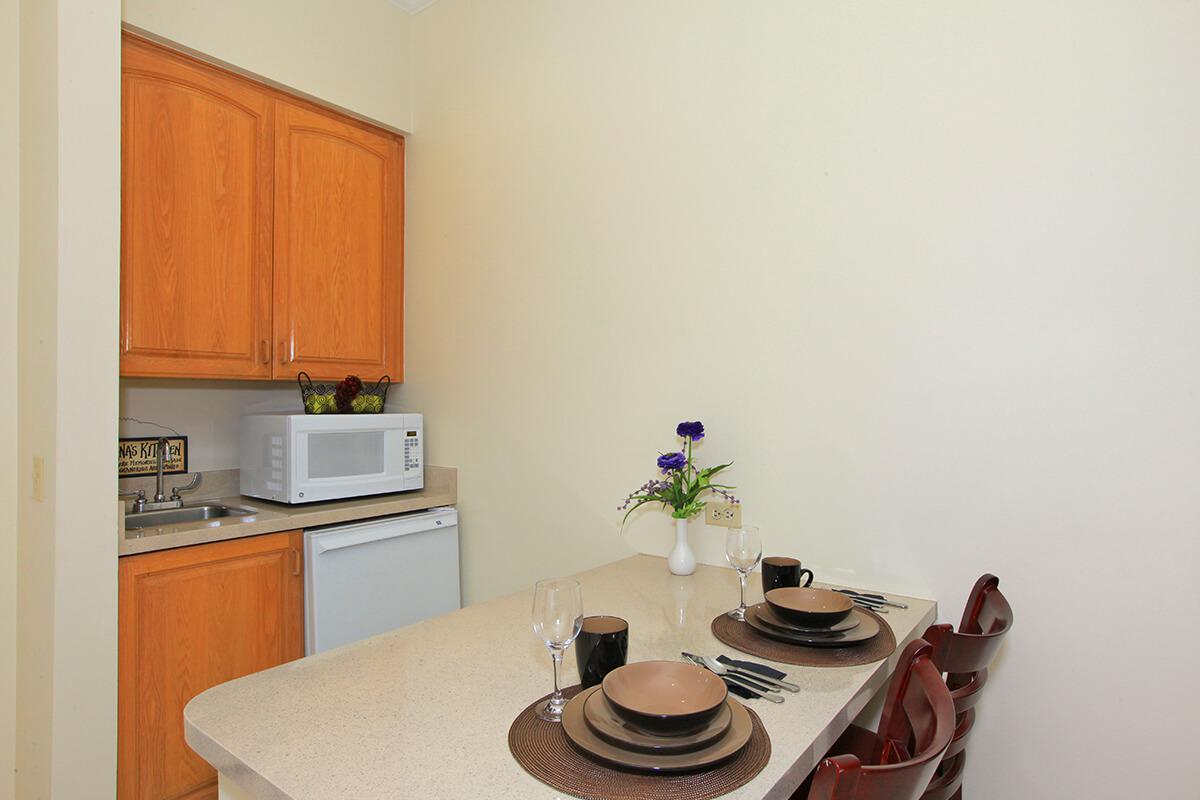 a stove top oven sitting inside of a kitchen