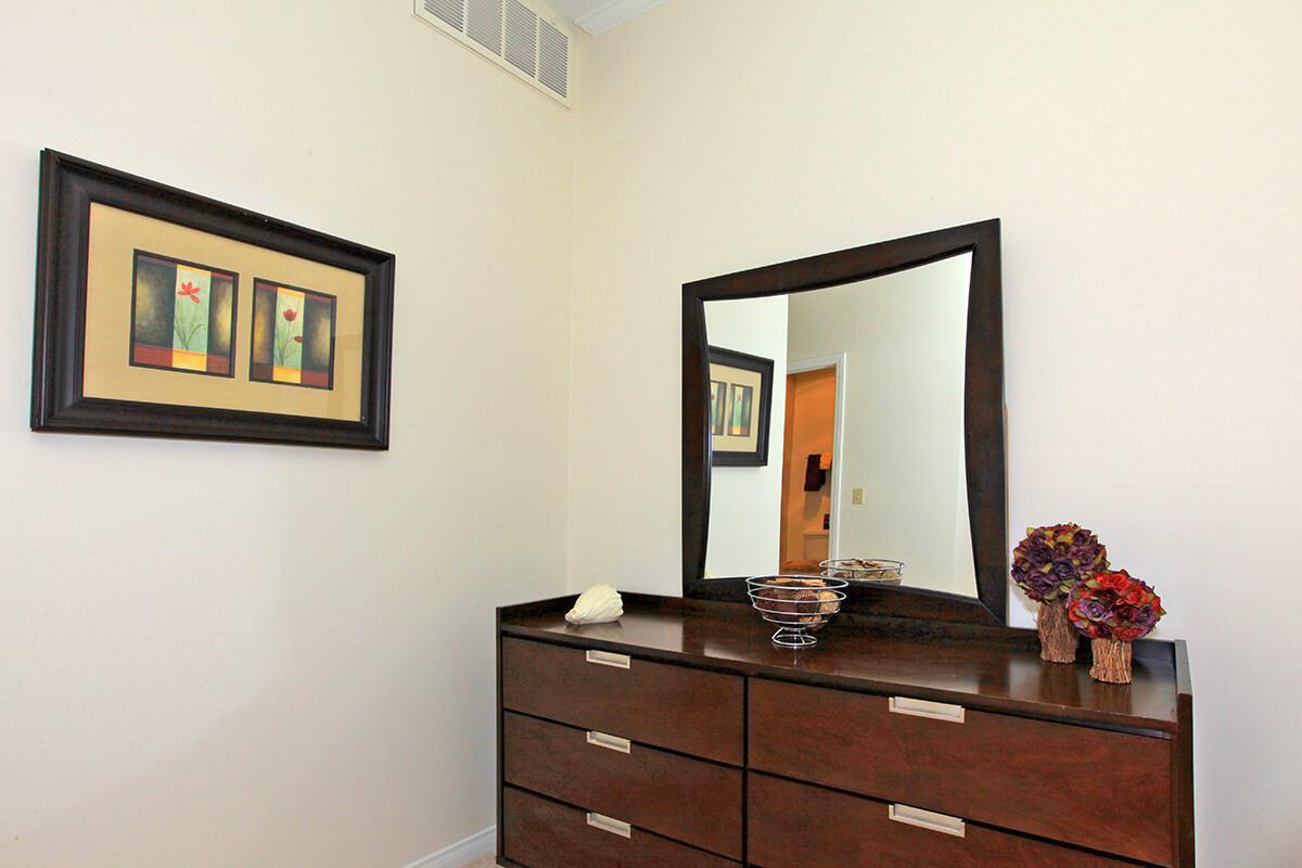 a bedroom with a bed and a mirror