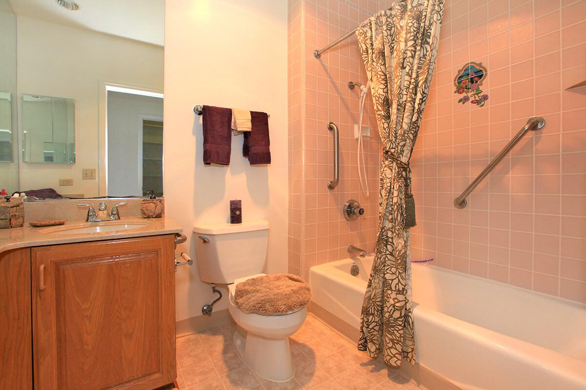 a white tub sitting next to a sink