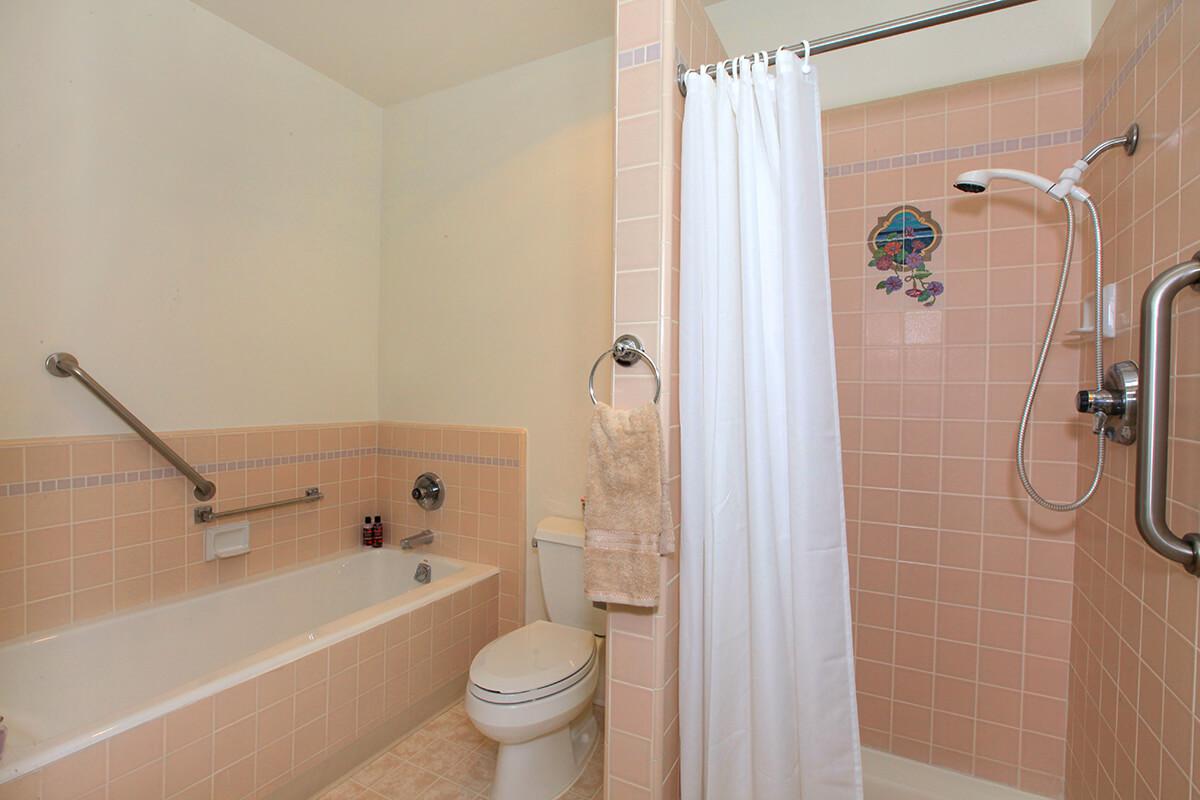 a small white sink in a tiled room