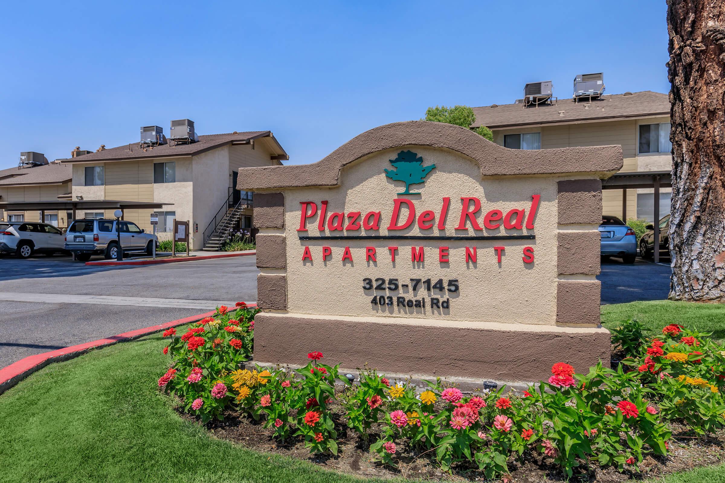 a colorful flower garden in front of a building