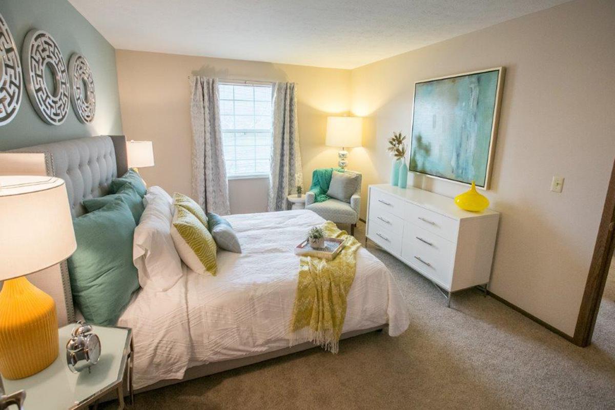 a bedroom with a view of a living room