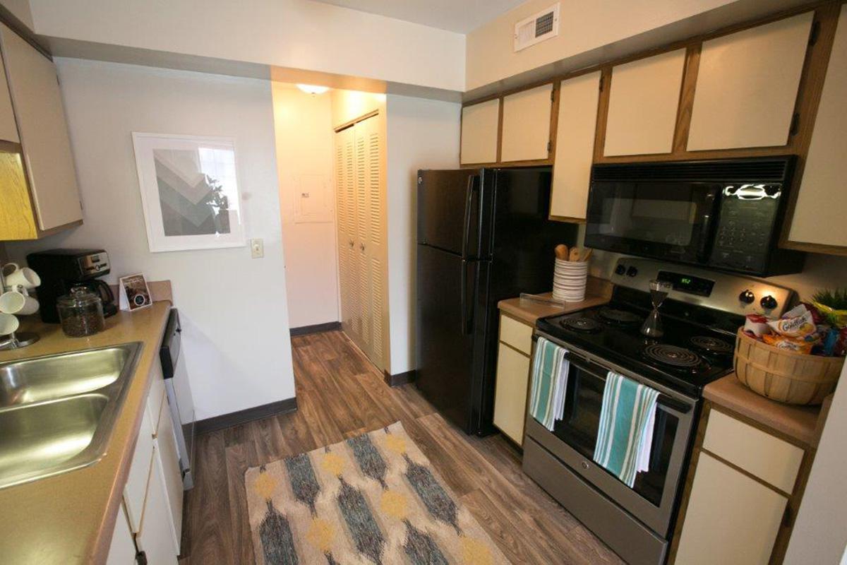 a modern kitchen with stainless steel appliances and wooden cabinets