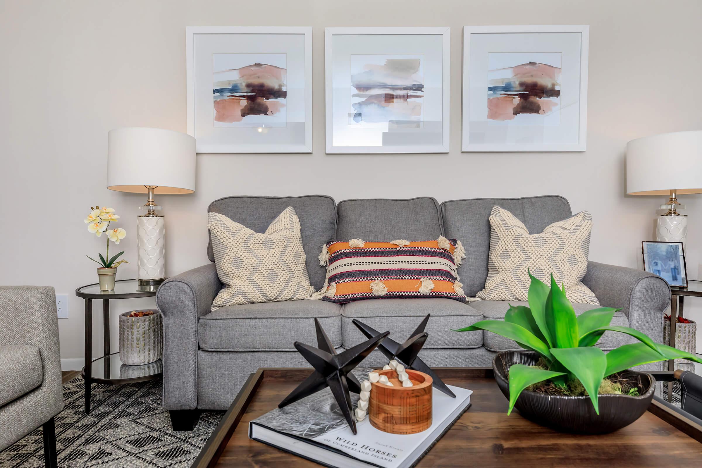 a living room filled with furniture and vase on a table