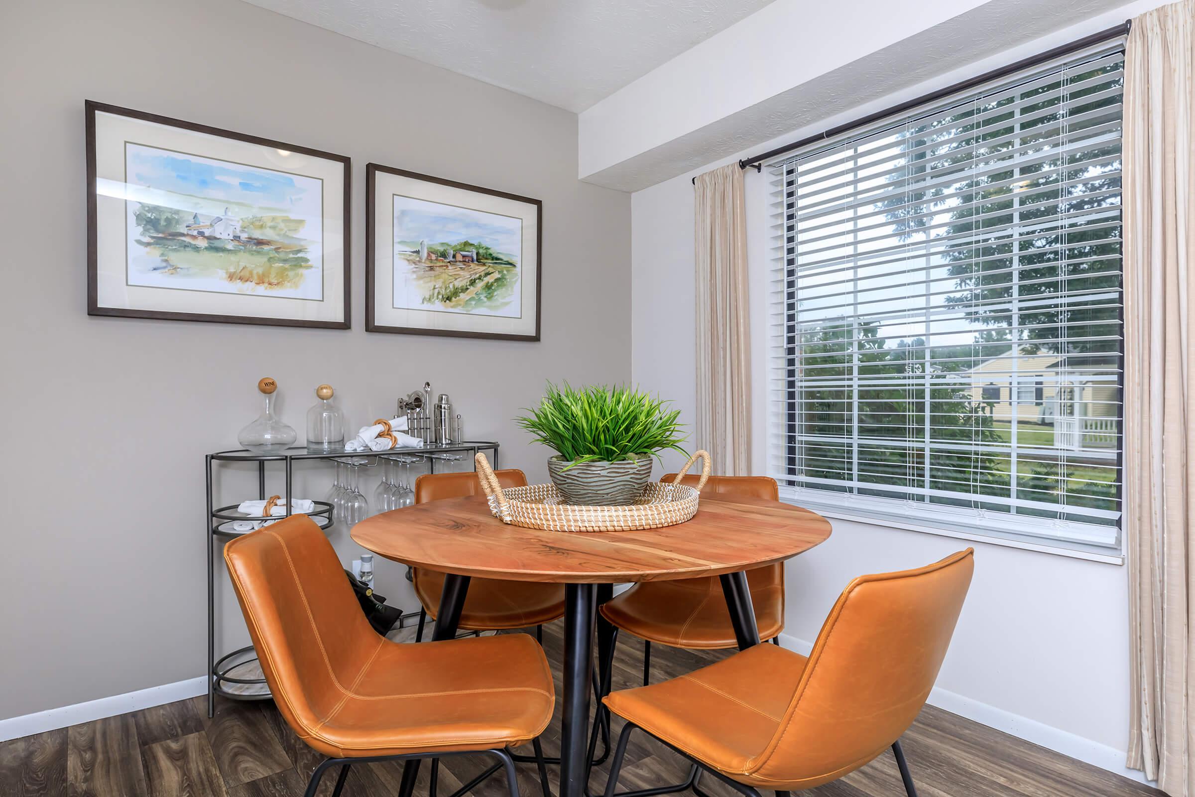 a dining room table in front of a window