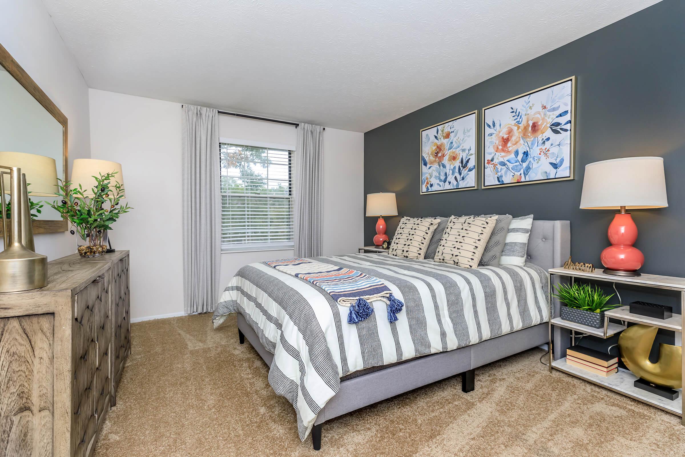 a bedroom with a bed and desk in a room