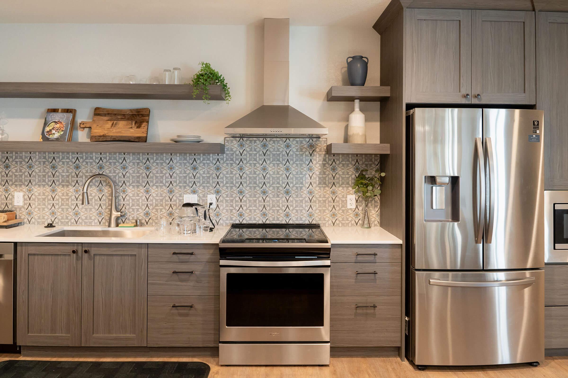 a kitchen with stainless steel appliances and wooden cabinets