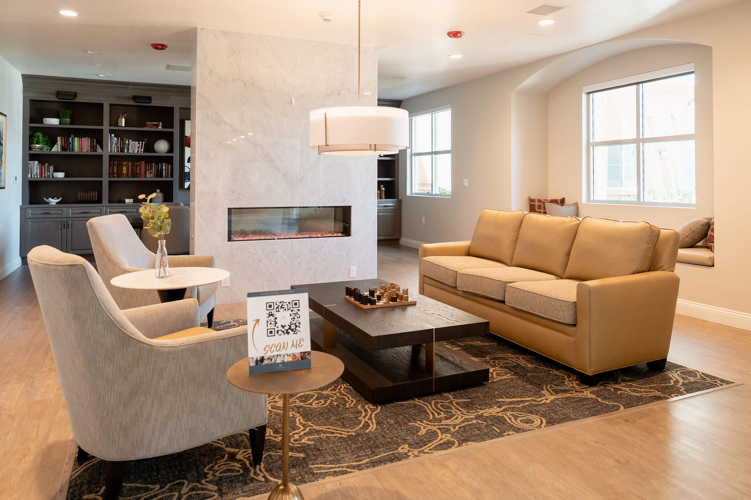 a living room filled with furniture and a large window