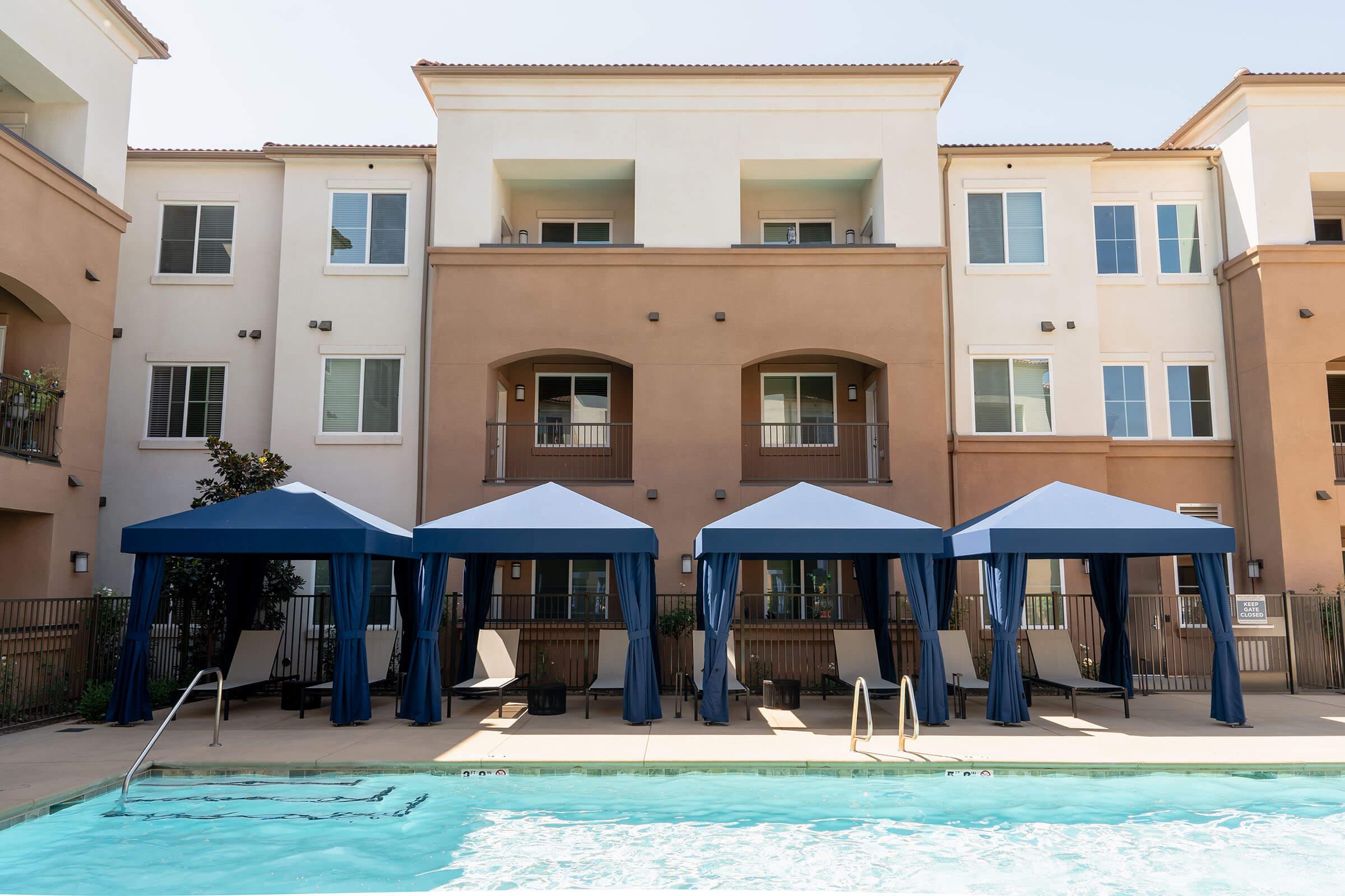 a house with a pool in front of a building