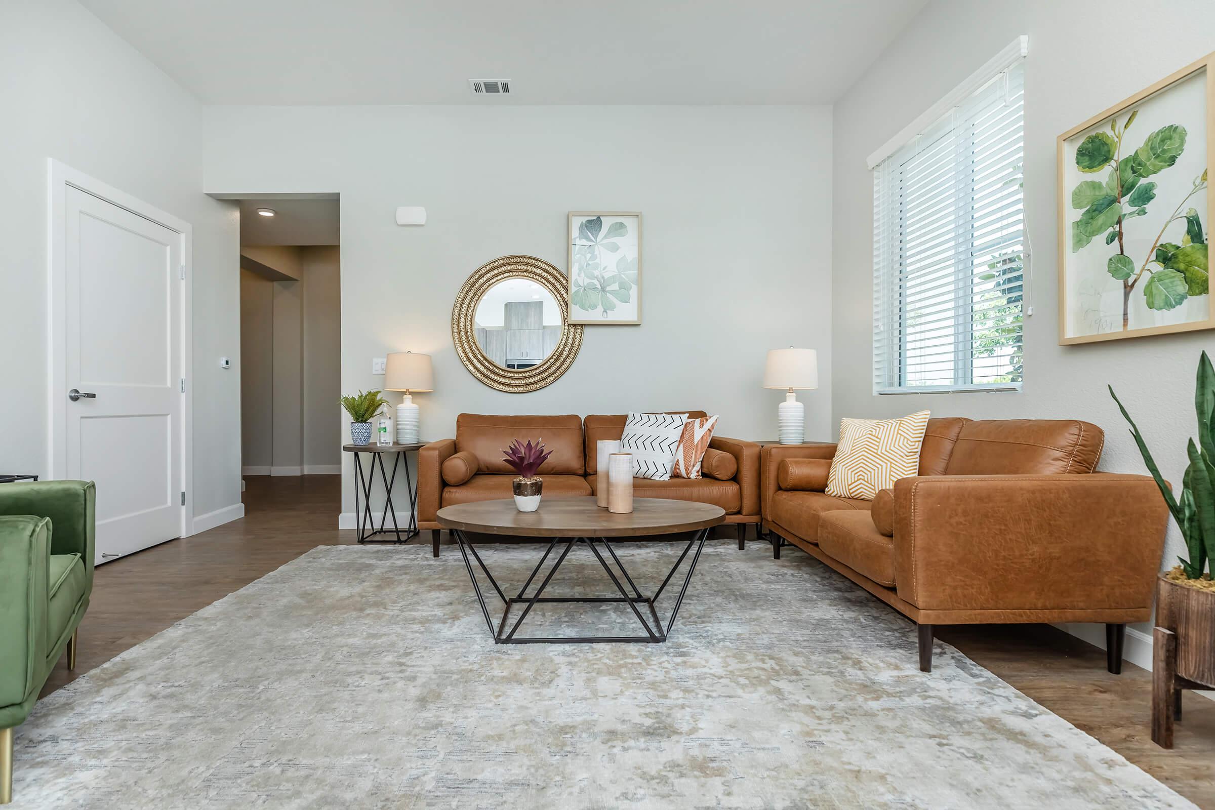 a living room filled with furniture and a large window