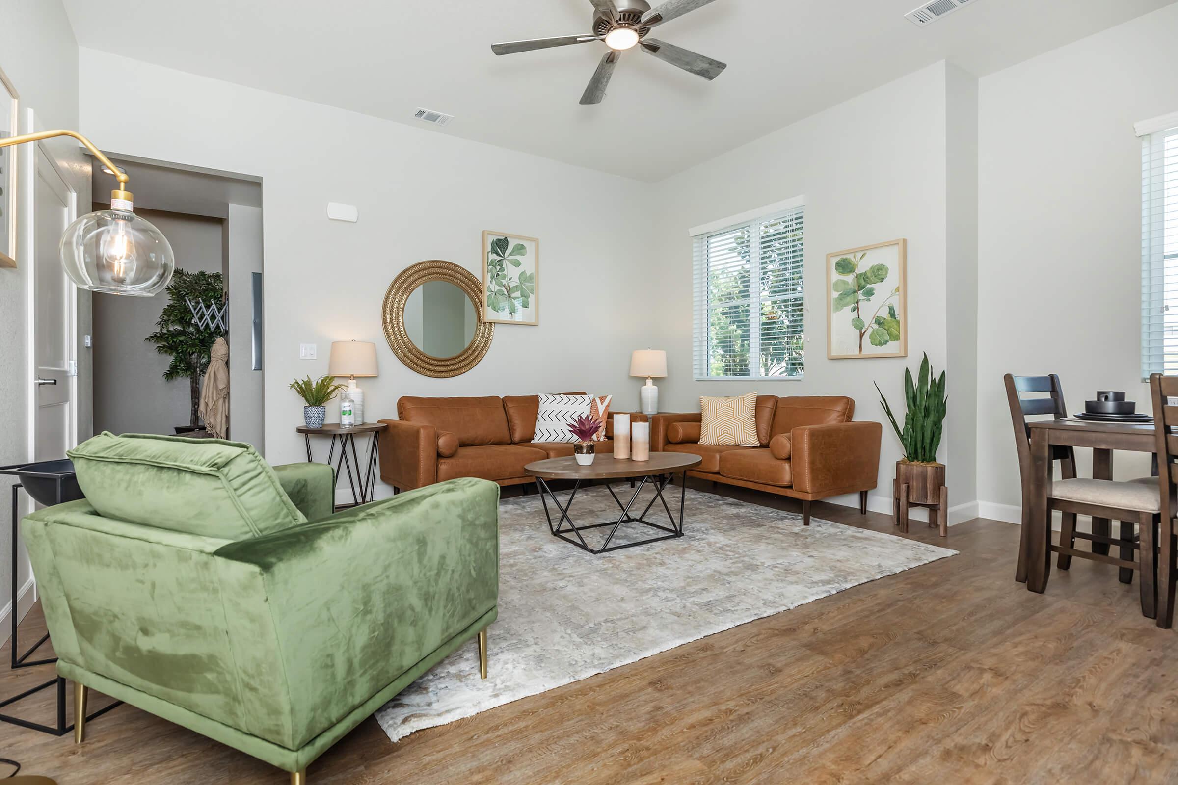 a living room filled with furniture and a large window